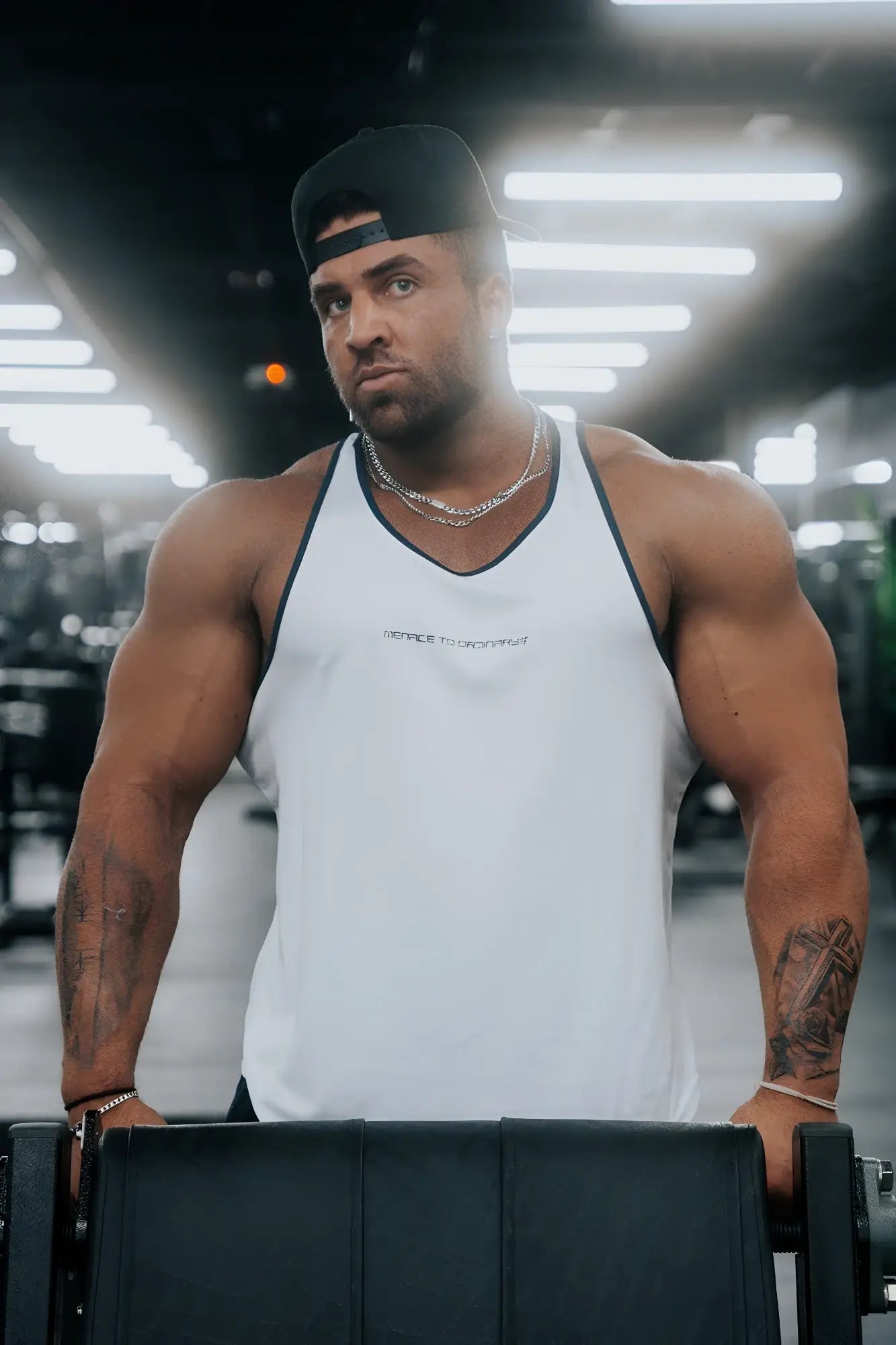 White fast-dry bodybuilding workout stringer tank top with black trim and small logo on chest for men