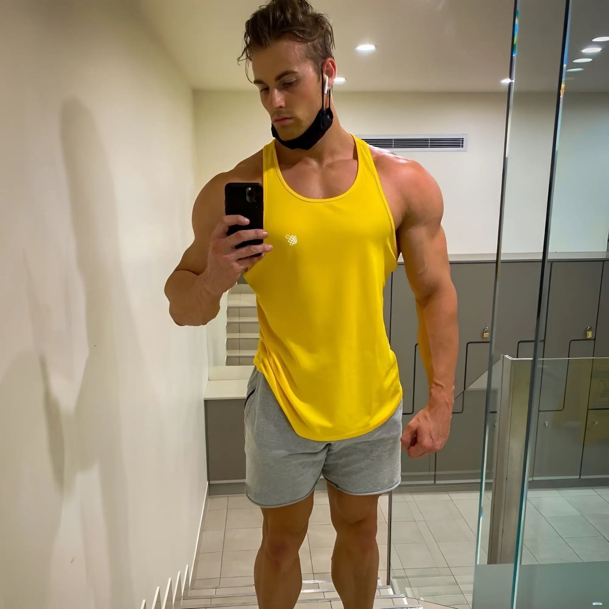 Jed North fast-dry bodybuilding workout stringer tank top in bright yellow with a small white logo on the chest