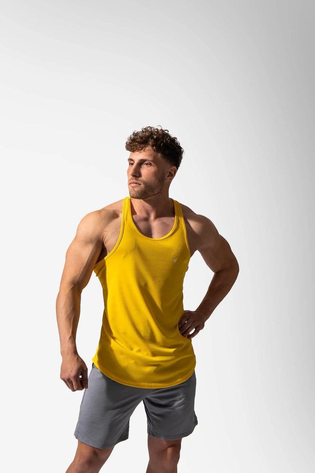 A vibrant yellow sleeveless fast-dry athletic tank top by Jed North designed for bodybuilding workouts