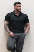 Black fast-dry polo t-shirt with short sleeves classic collar and subtle ribbed texture for active wear
