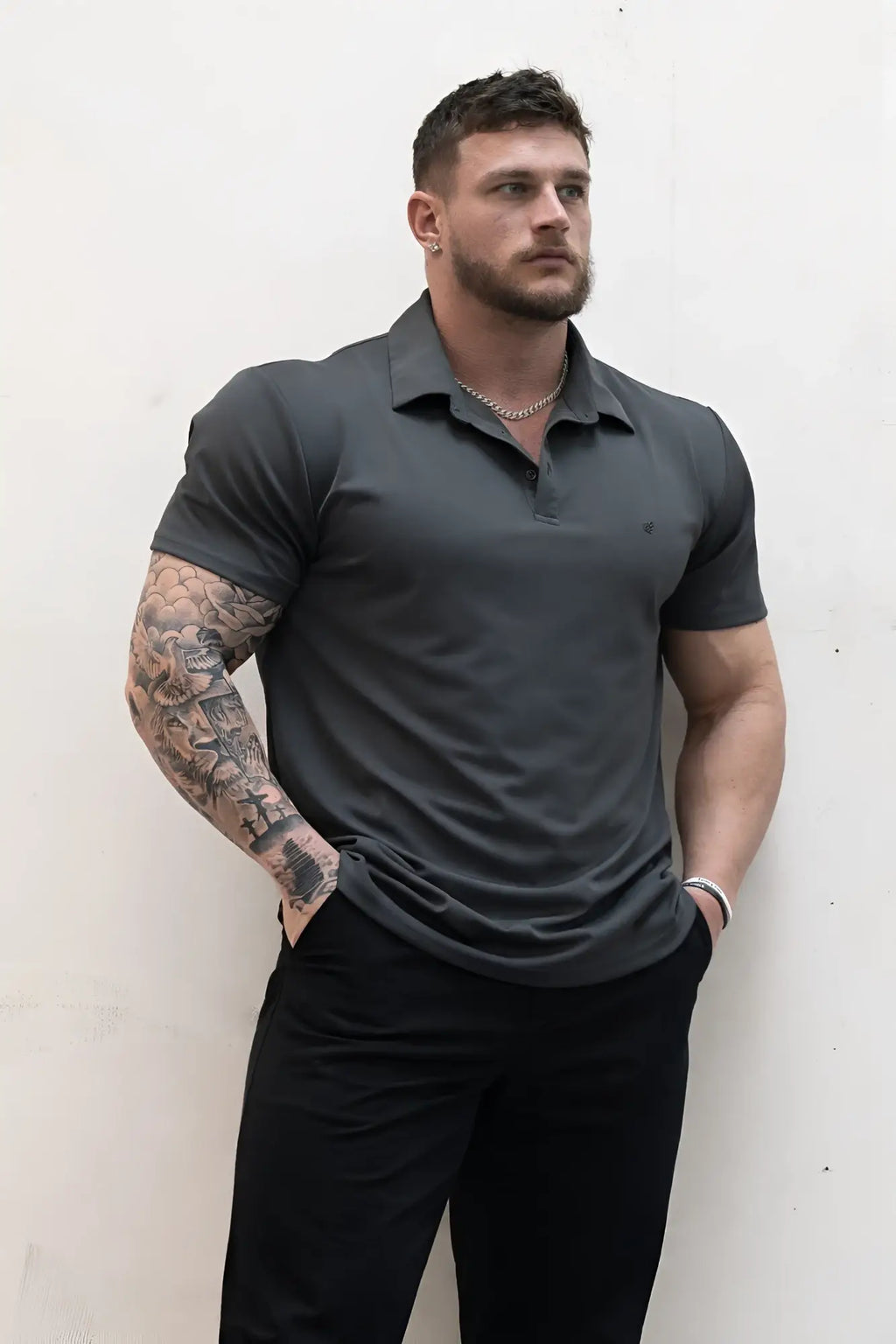 Dark gray fast-dry short-sleeved polo shirt with classic collar and subtle chest branding for casual wear