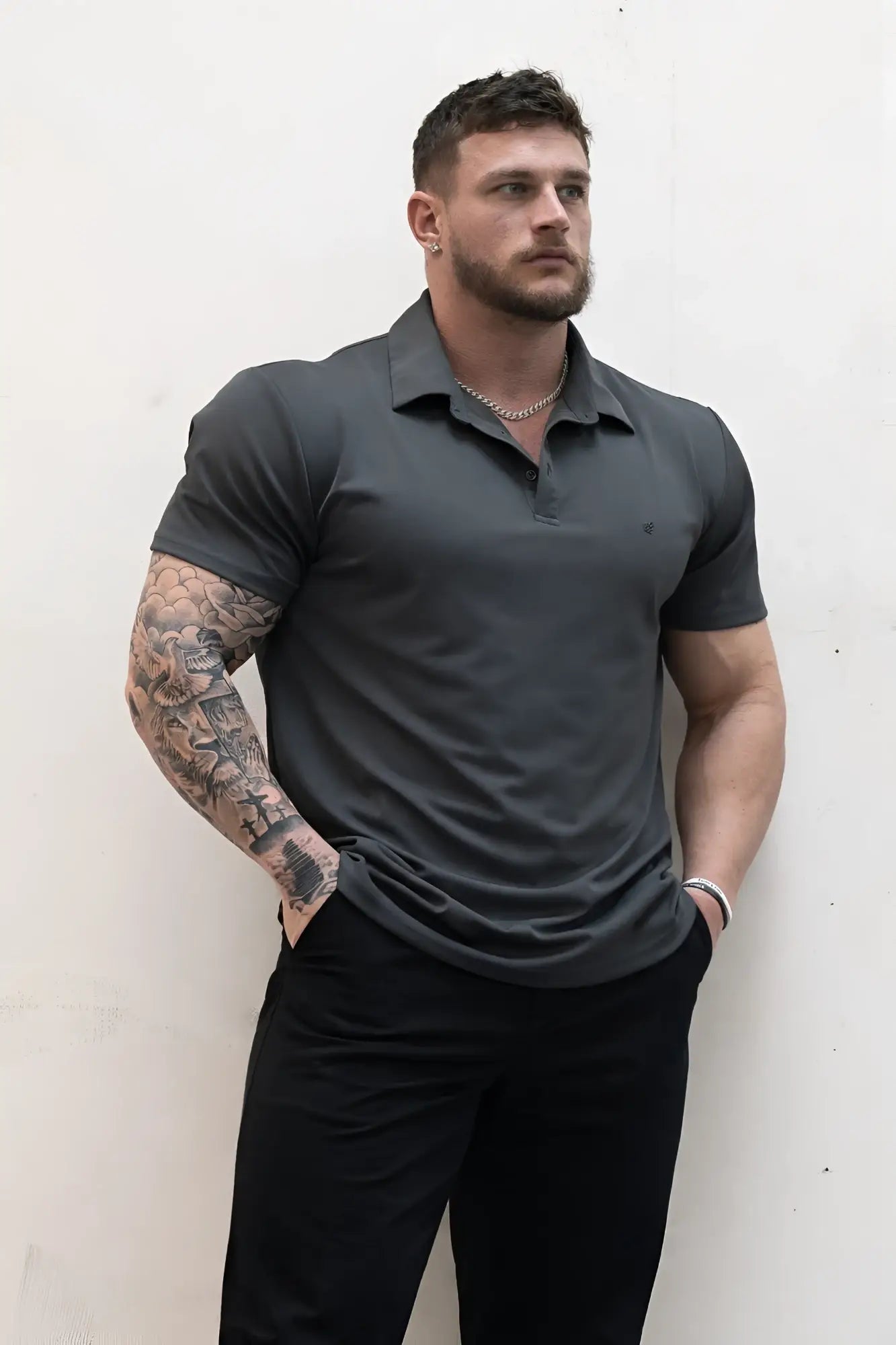 Dark gray fast-dry short-sleeved polo shirt with classic collar and subtle chest branding for casual wear