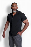 Black short-sleeved flex premium stretch button-up shirt with collar and subtle stitching details in onyx black