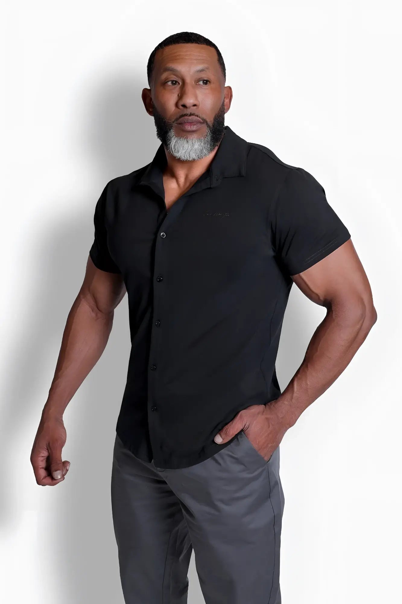 Black short-sleeved flex premium stretch button-up shirt with collar and subtle stitching details in onyx black