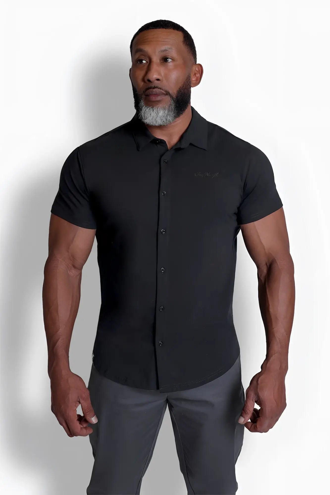 Black short-sleeved flex premium stretch button-up shirt in onyx black with subtle embroidered logo on chest