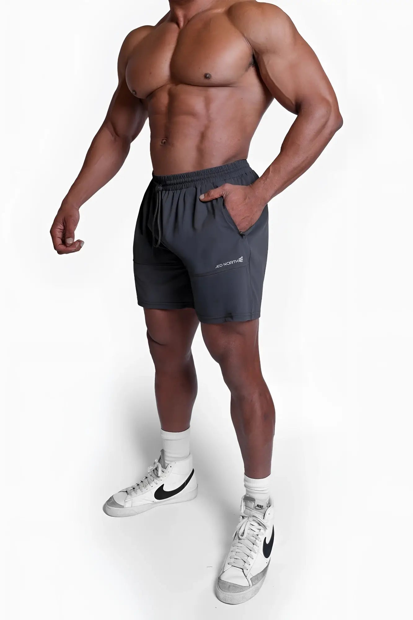 Fortis men’s athletic shorts in black with drawstring waistband, side pockets, and subtle white logo on left thigh