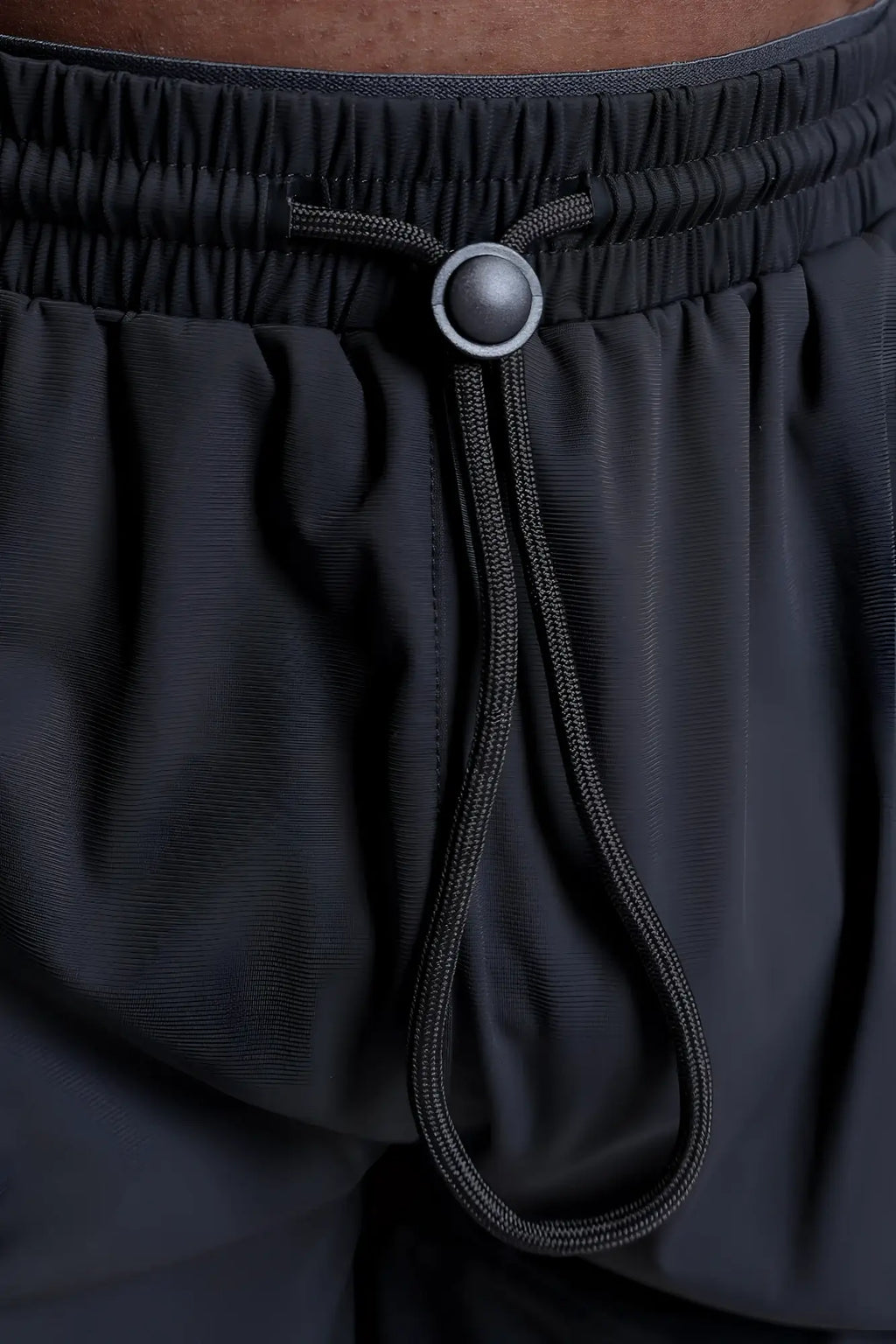 Fortis men’s athletic shorts in black with a drawstring waistband and silver-toned button for adjustable fit