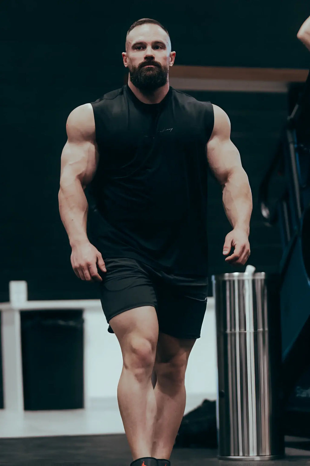 Black sleeveless athletic top with subtle logo on the chest paired with fortis men’s black athletic shorts
