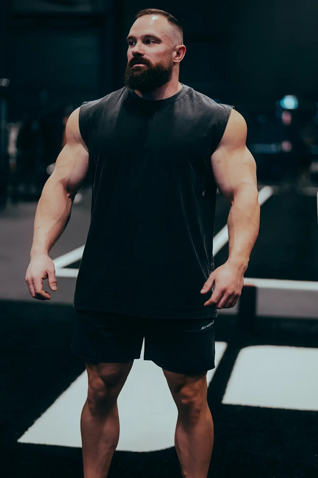 A black sleeveless athletic tank top with a simple fitted design for men, ideal for sports and workouts