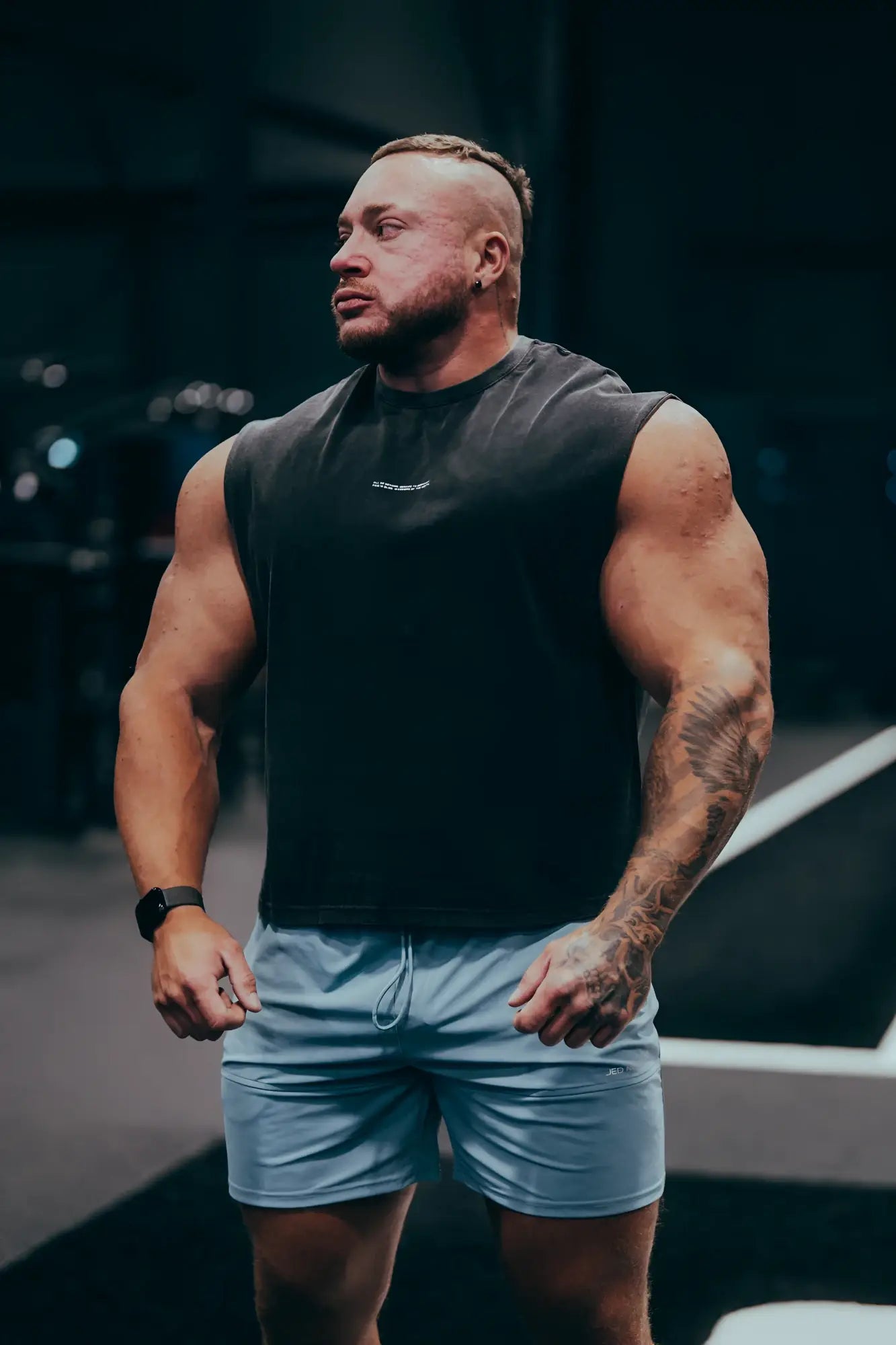A man wearing Fortis men’s athletic light blue shorts suitable for sports and workout activities