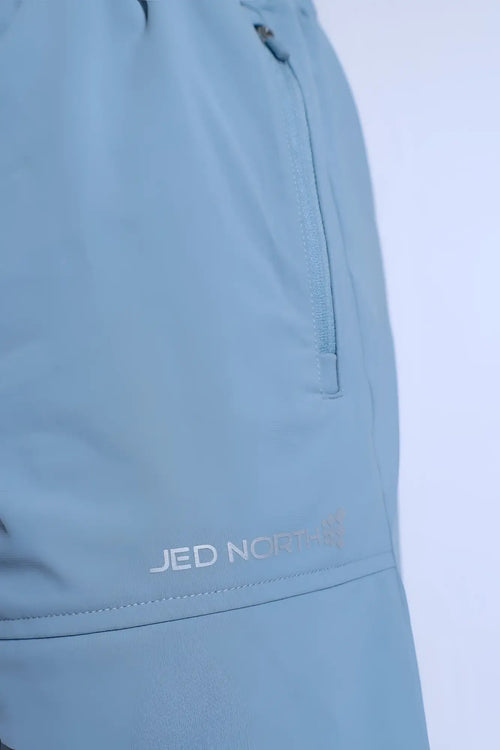 Fortis men’s light blue athletic shorts with subtle textured fabric and zippered side pocket featuring jed norris logo