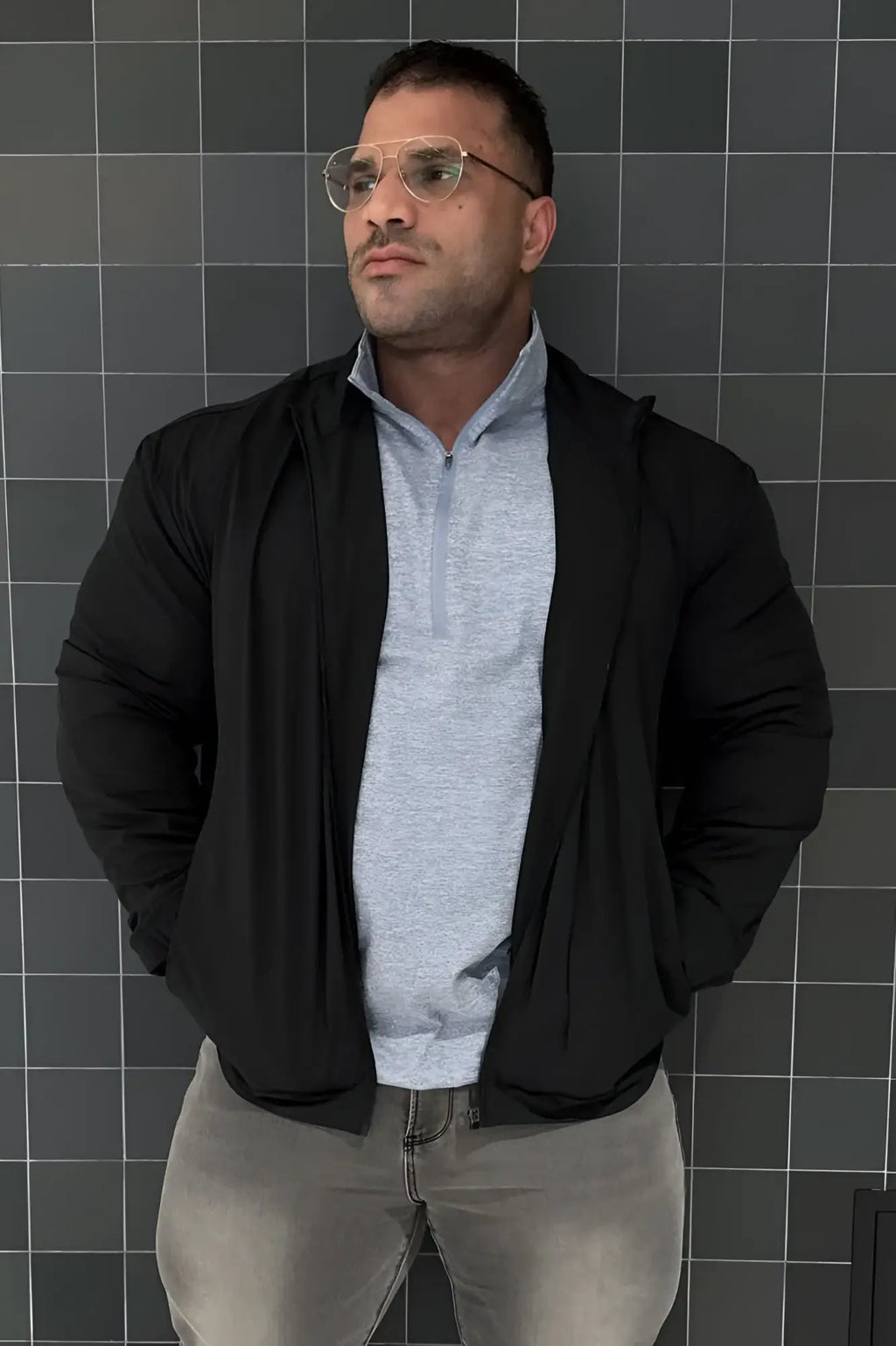 Full-zip training jacket black with sleek modern design and subtle texture in a black zip-up hoodie style