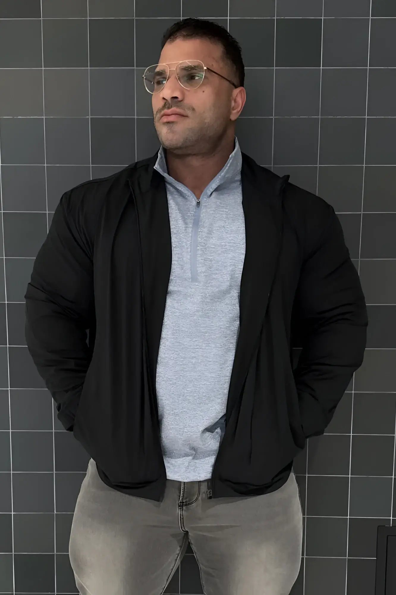 Full-zip training jacket black with sleek modern design and subtle texture in a black zip-up hoodie style