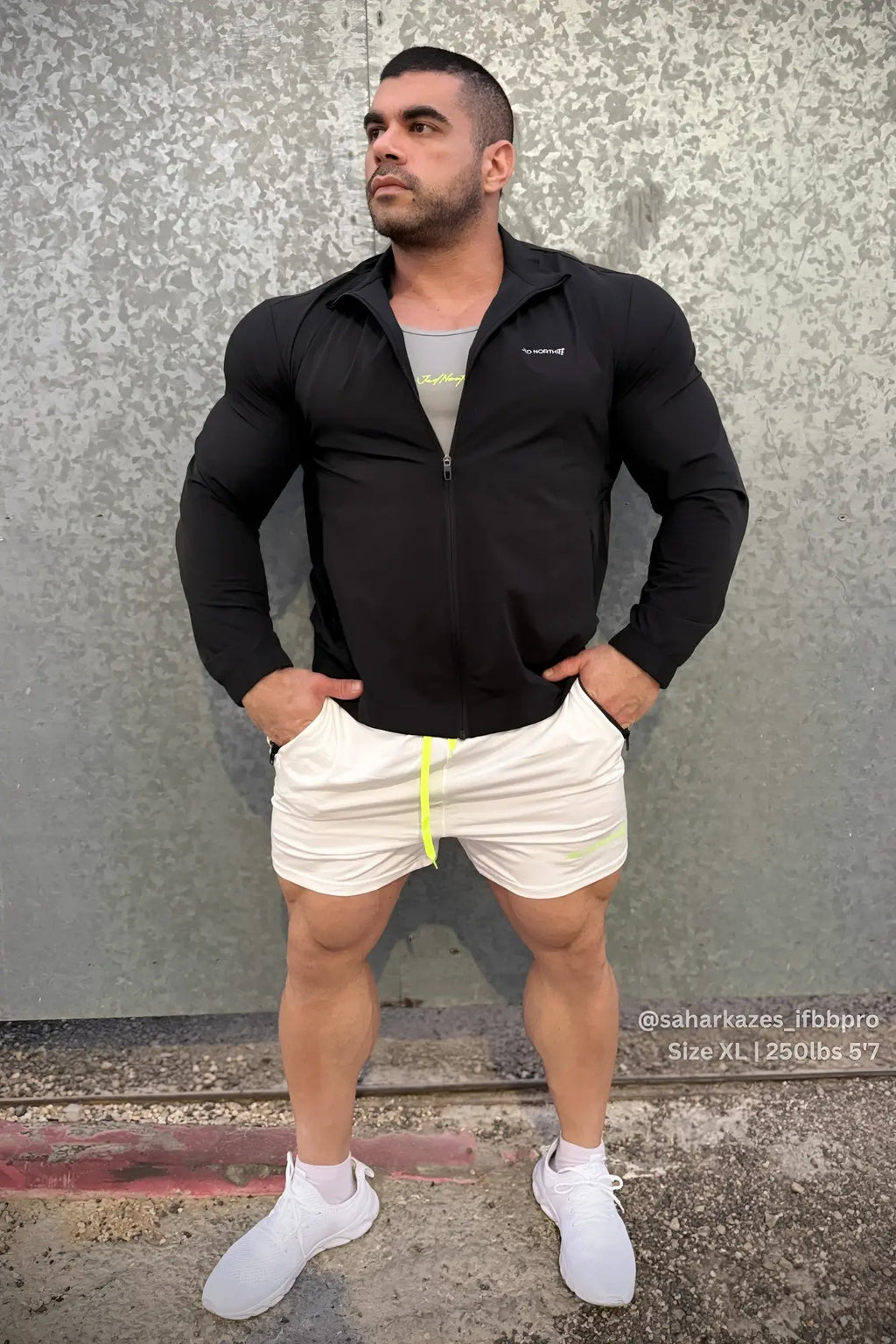 Full-zip training jacket in black with a subtle chest logo designed for comfortable workout wear