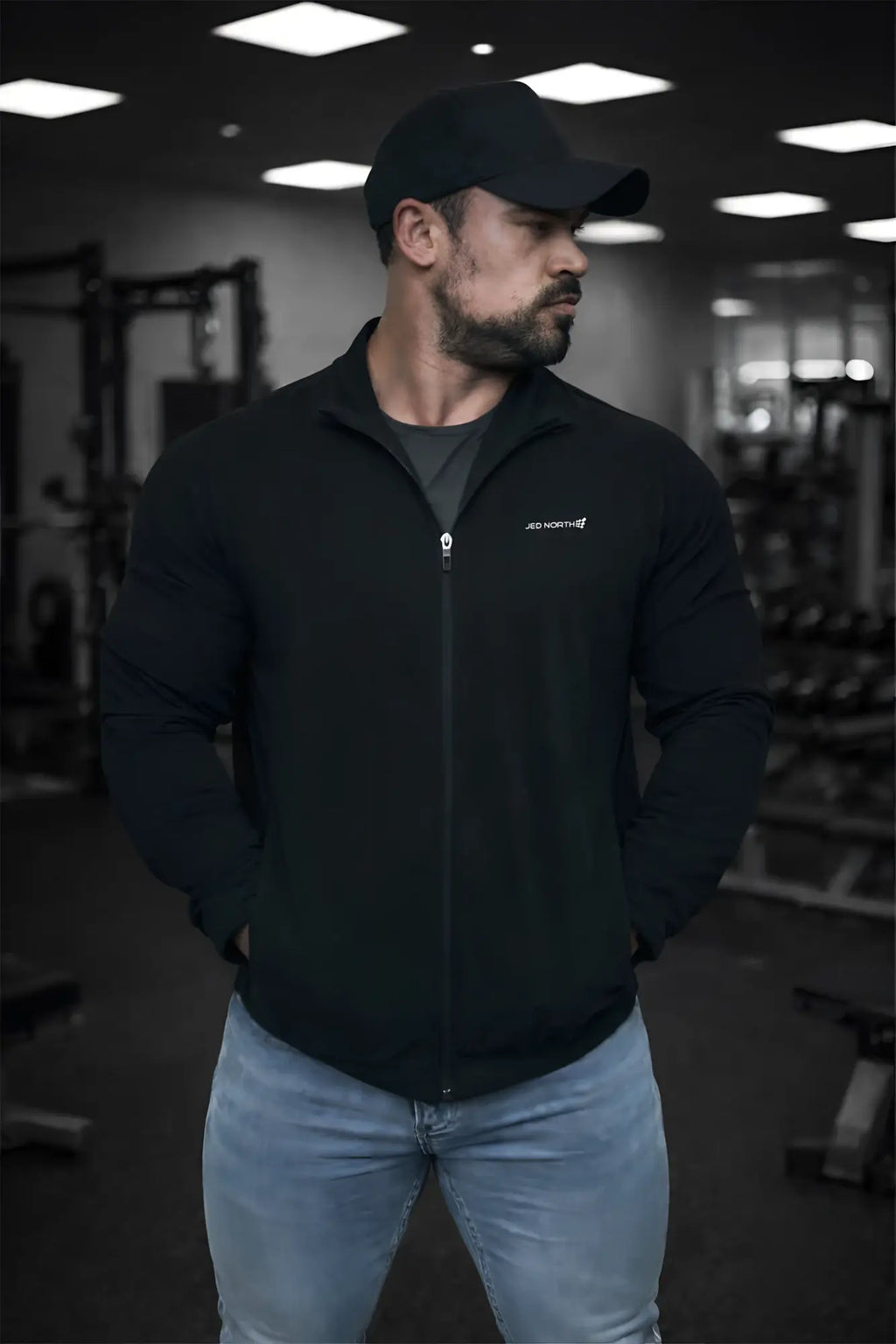 Full-zip training jacket in black with a subtle white logo on the left chest perfect for workouts