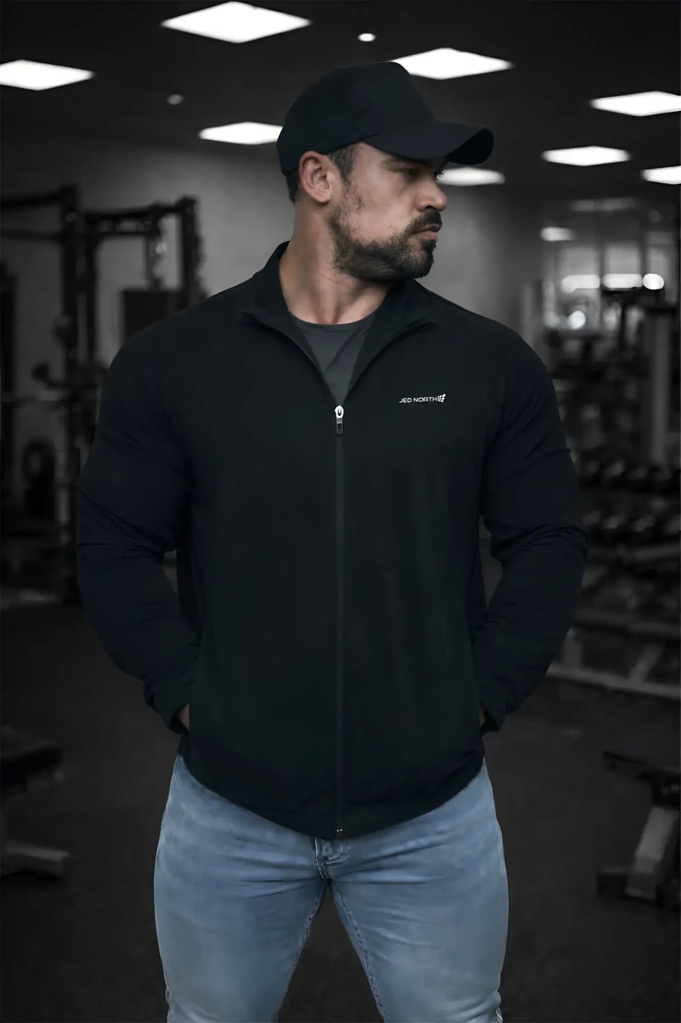 Full-zip training jacket in black with a subtle white logo on the left chest perfect for workouts
