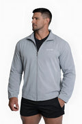Light gray full-zip training jacket with subtle brand logo on left chest designed for athletic wear
