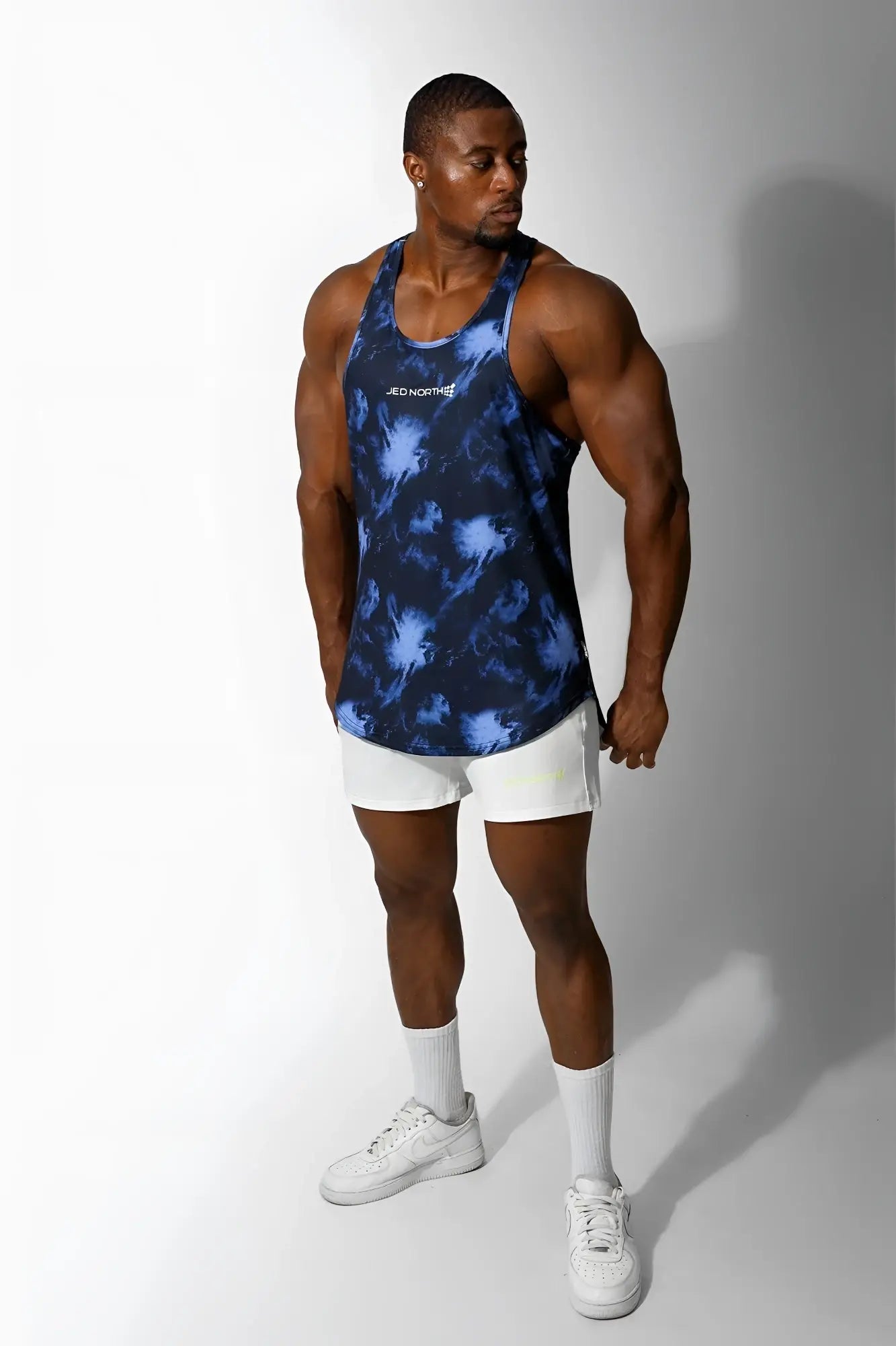 Jed north graphic muscle stringer tank top in blue and black tie-dye with a subtle white chest logo