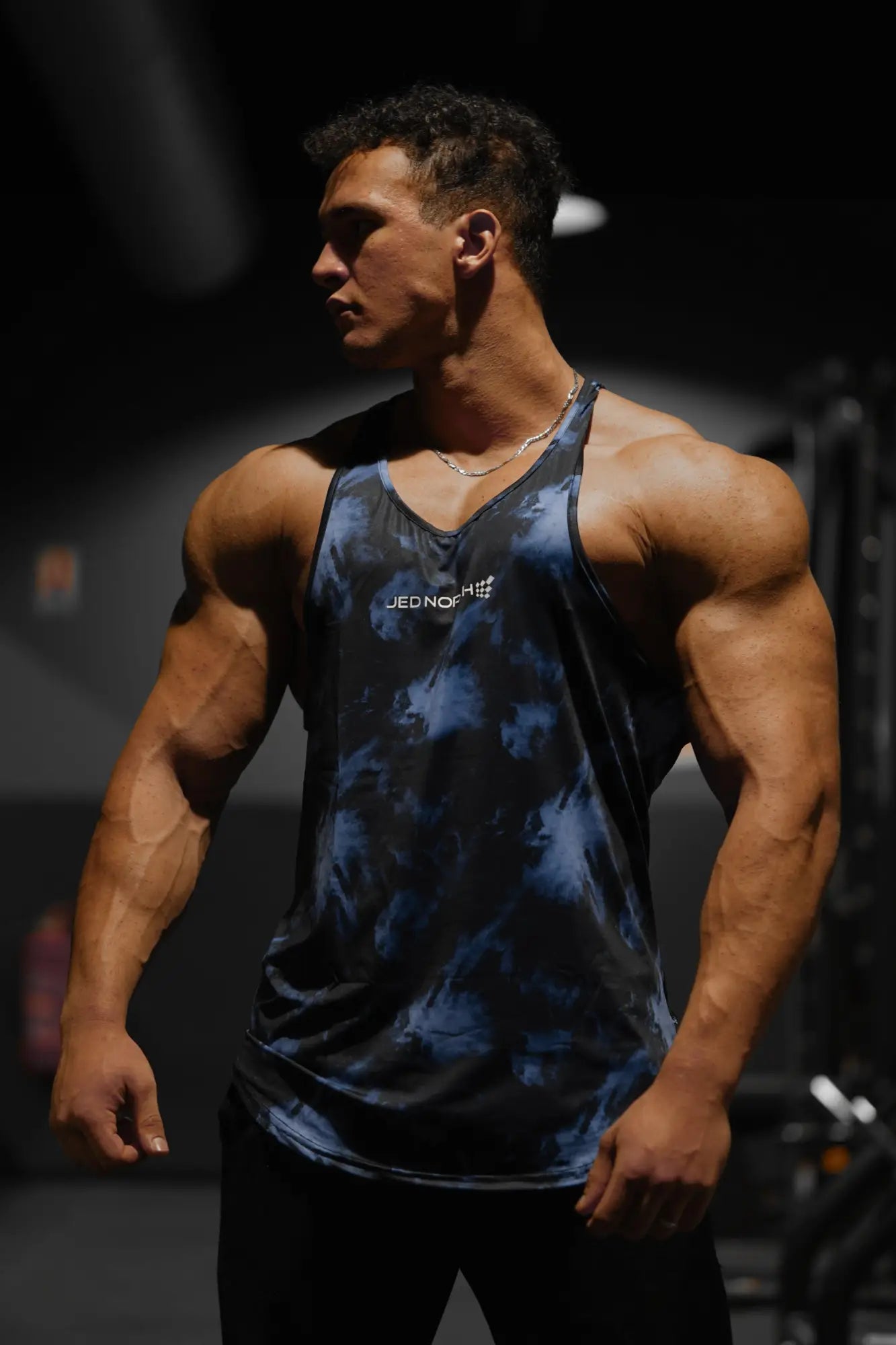 Blue and black tie-dye stringer tank top with white logo chest graphic from jed north abstract blue collection