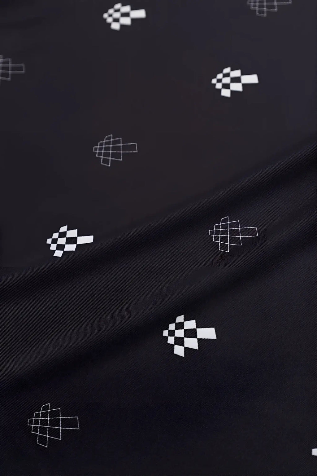 Black fabric with white pixelated checkered flag pattern on the jed north graphic muscle stringer black jn logo