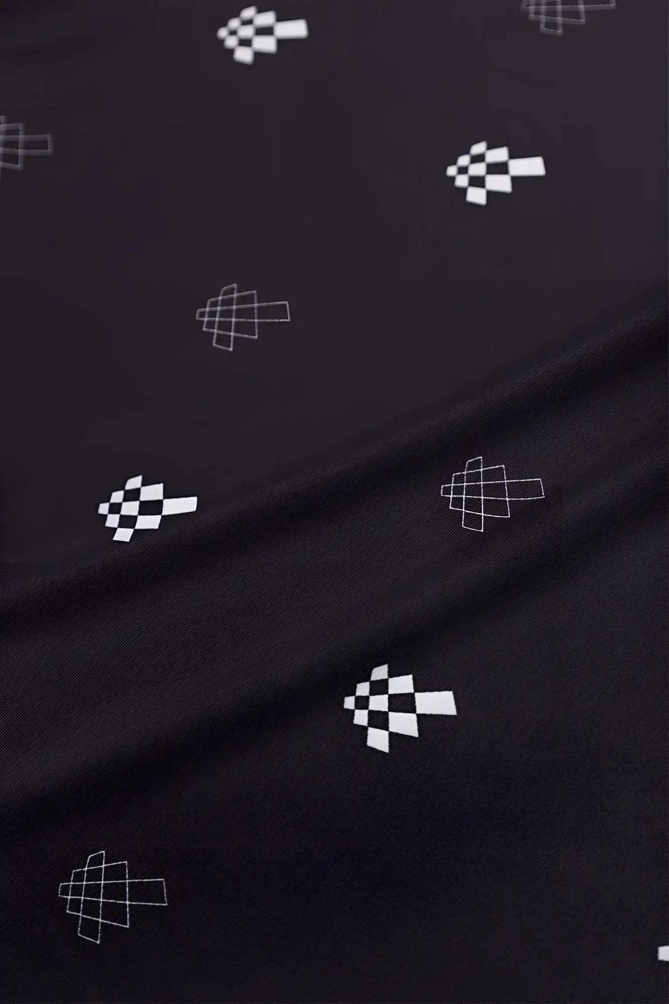 Black fabric with white pixelated checkered flag pattern on the jed north graphic muscle stringer black jn logo