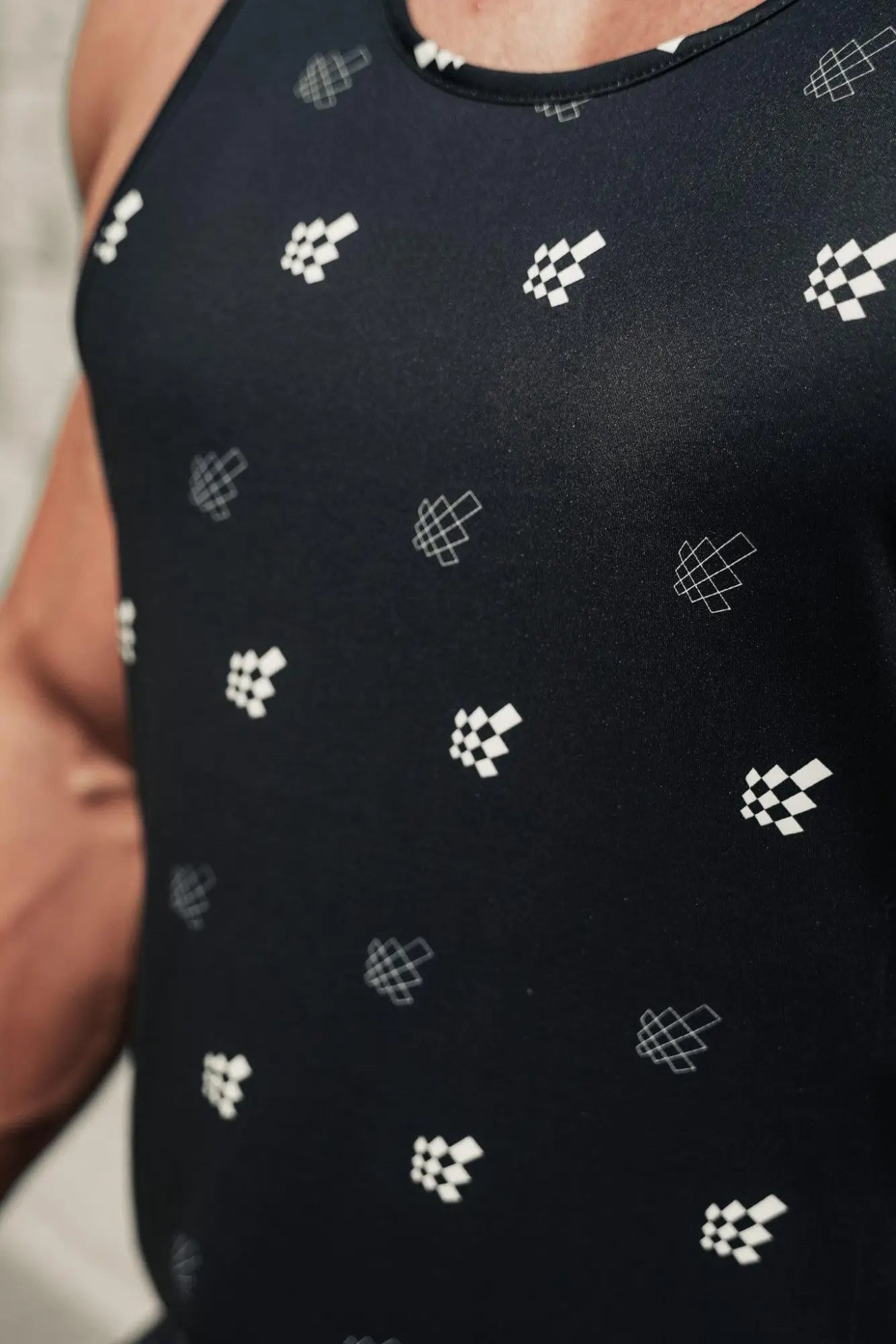 Black sleeveless muscle stringer with subtle white pixelated pattern by Jed North featuring JN logo