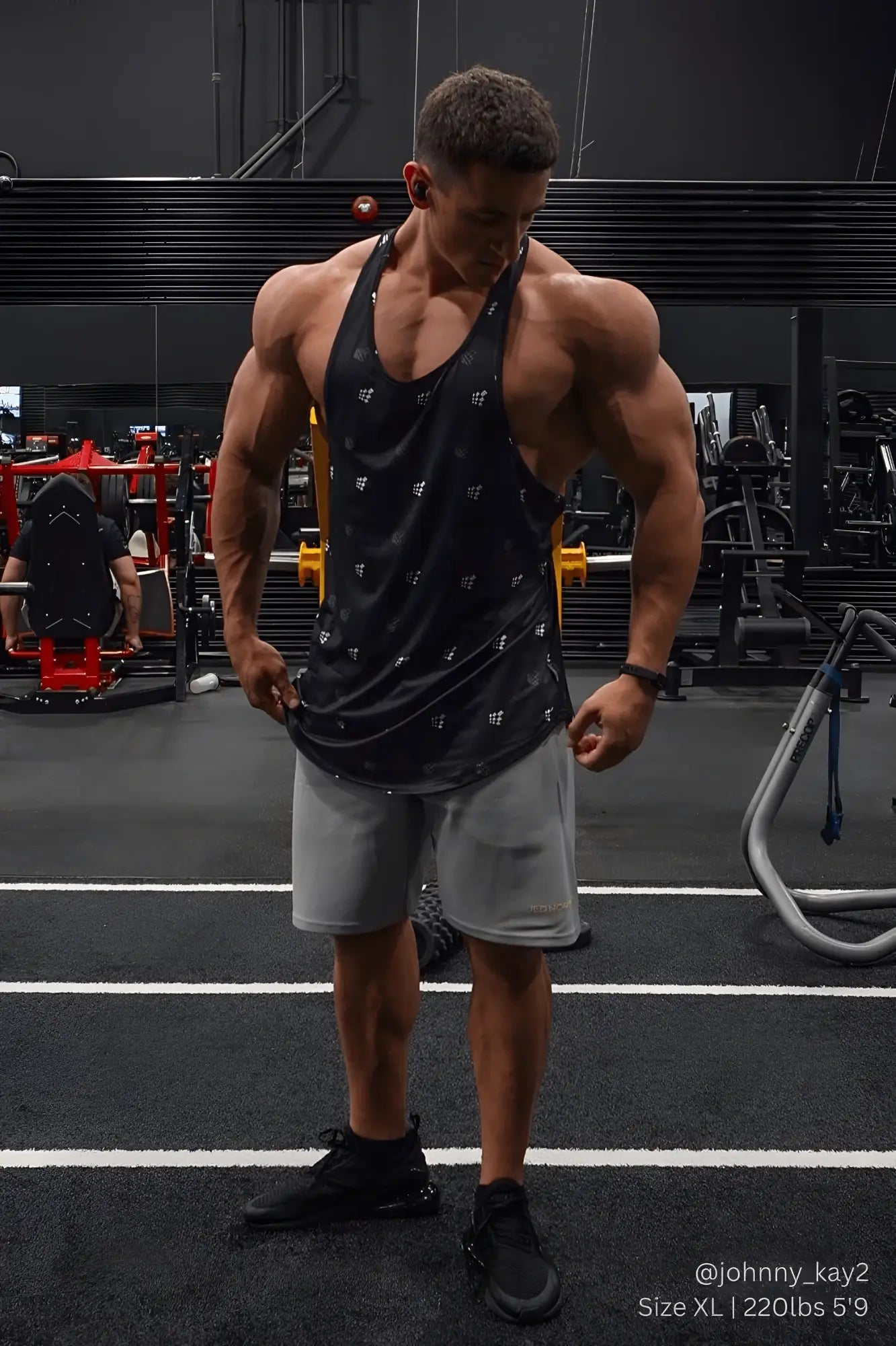 Black jed north graphic muscle stringer tank top with subtle white pattern worn by muscular individual in gym