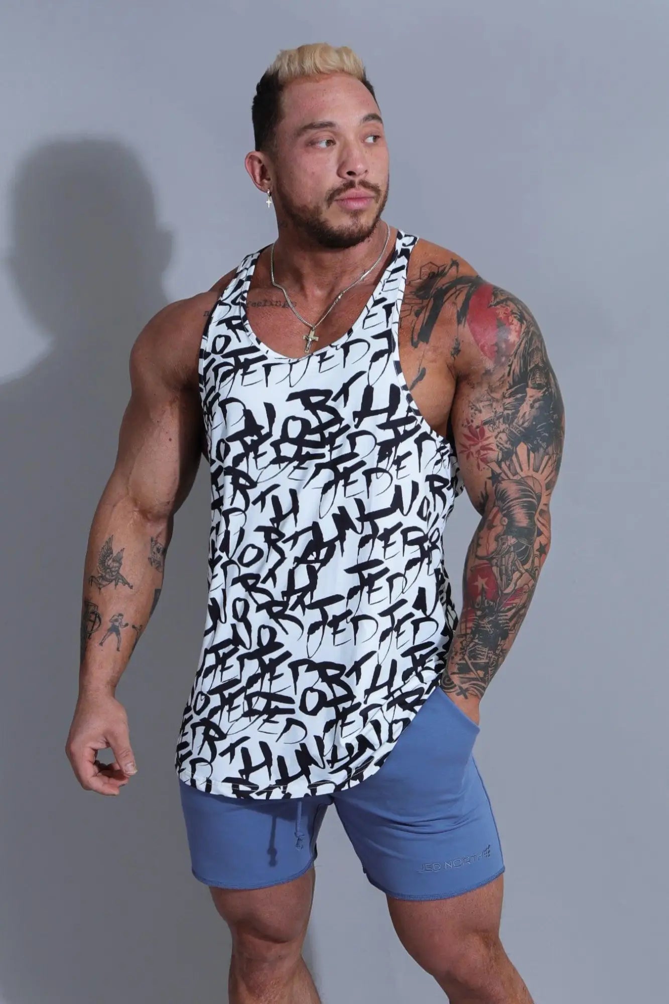 White jed north graphic muscle stringer tank top with black graffiti style lettering for gym and casual wear