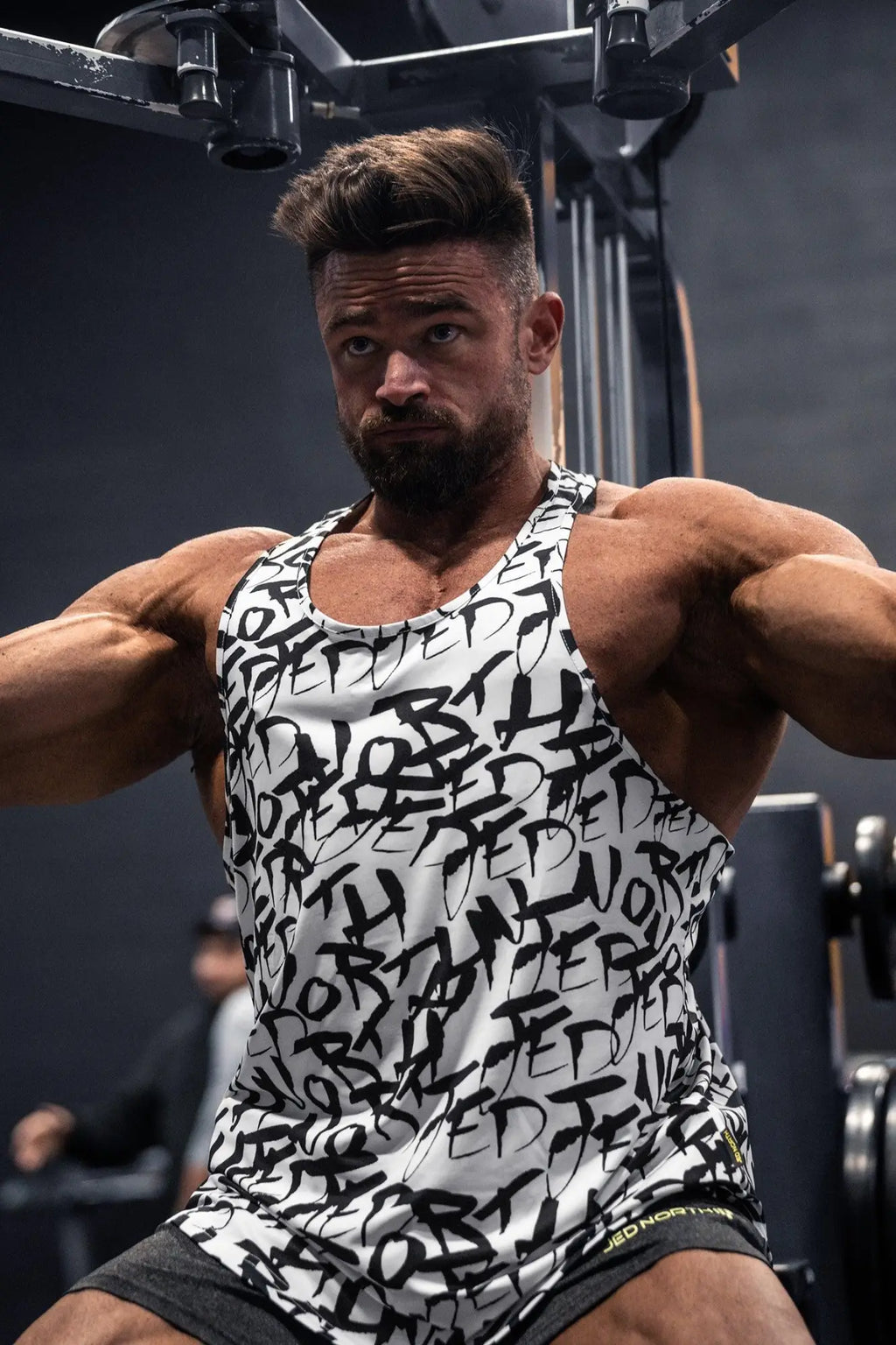 White tank top jed north graphic muscle stringer with black graffiti lettering made of stretchy athletic fabric