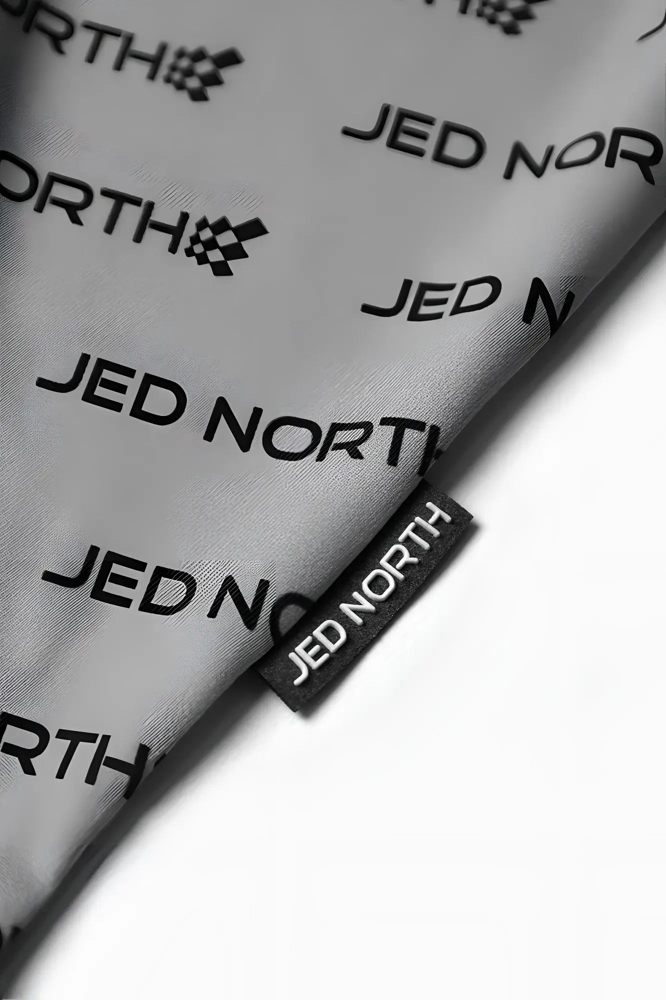 Gray jed north graphic muscle stringer featuring repeating black jed north logo print and matching brand tag