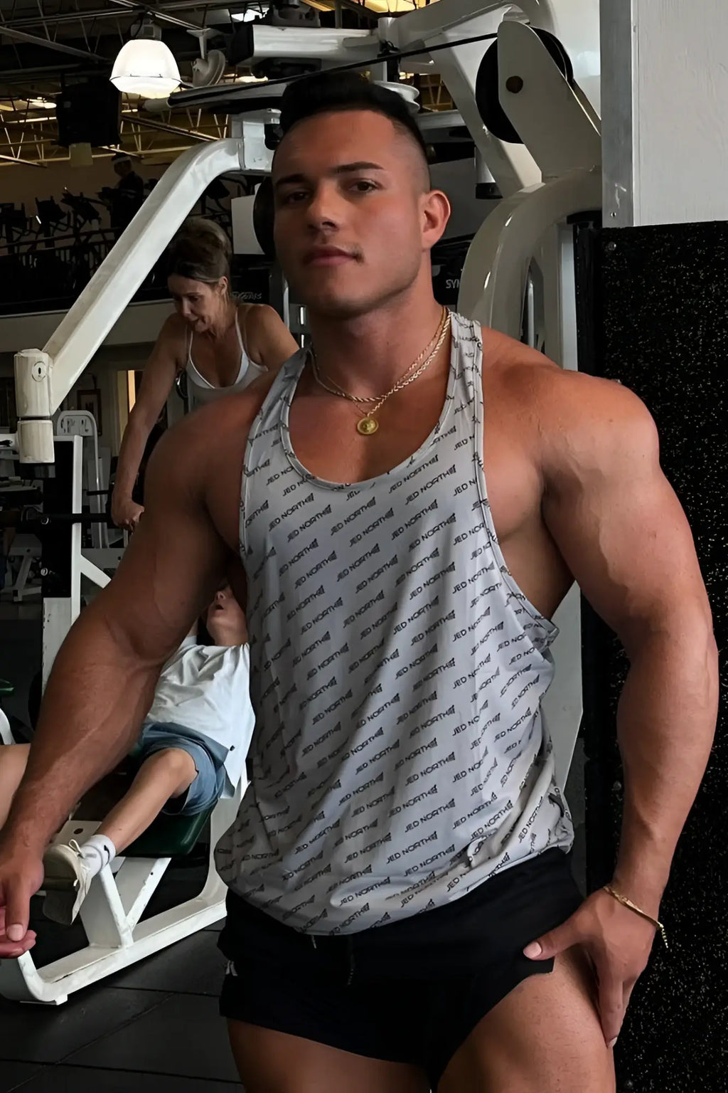 Gray jed north graphic muscle stringer tank top featuring a repeating motivation text pattern for workout use