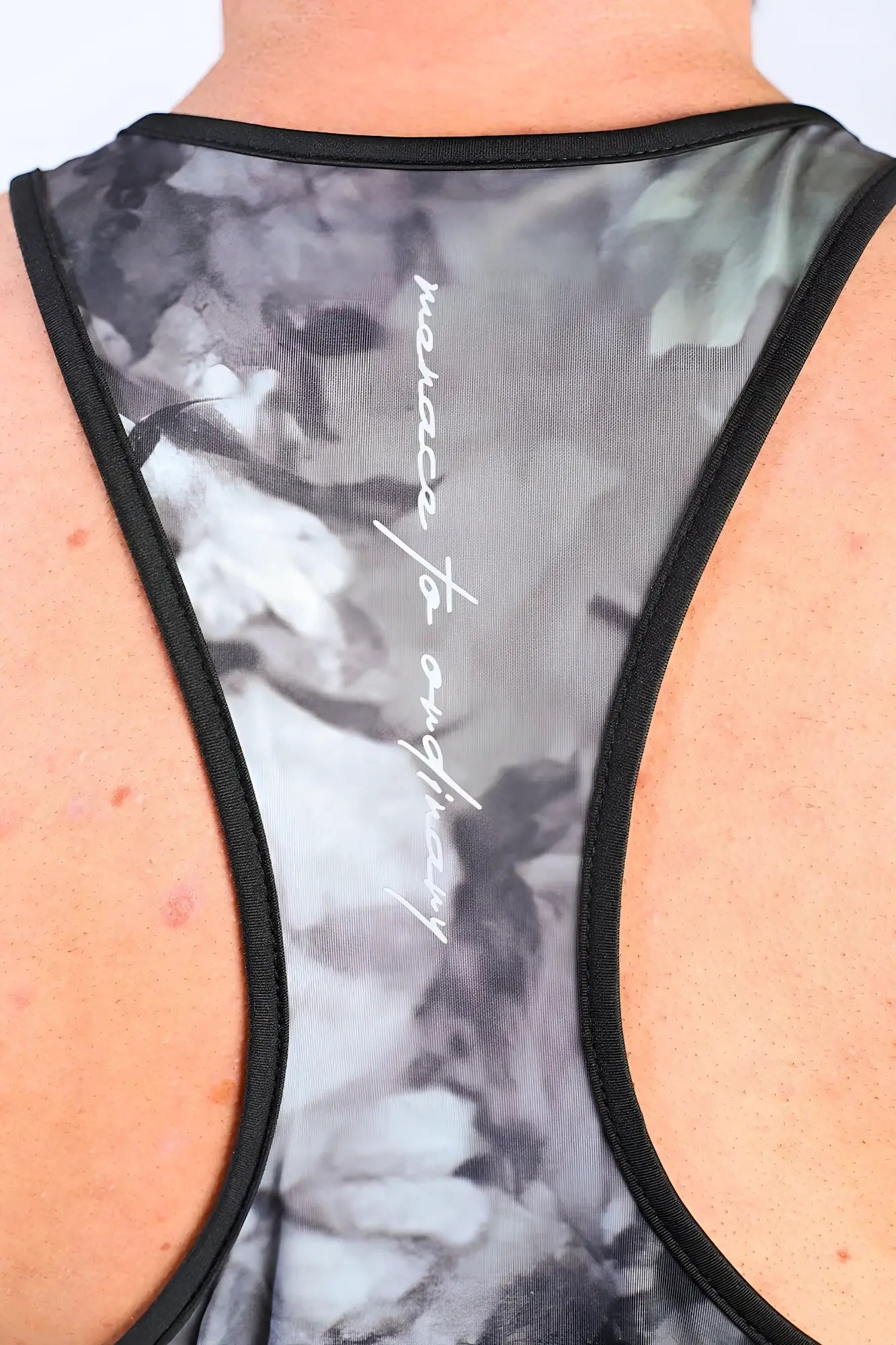 Back side of a jed north graphic muscle stringer hunter camo tank top featuring a black and gray abstract floral racerback with a script logo