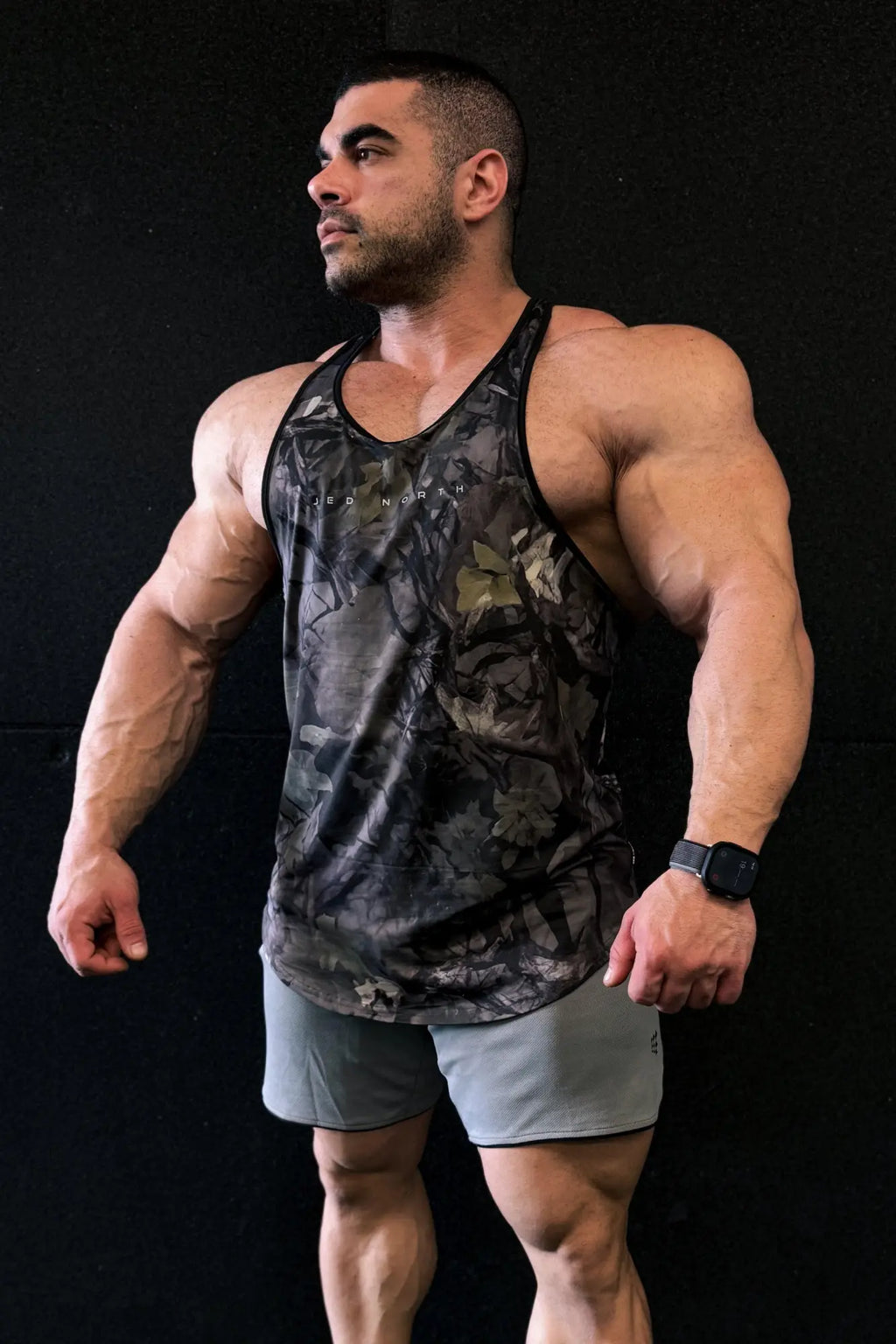 Black and gray camouflage jed north graphic muscle stringer tank top with subtle chest logo for athletic wear