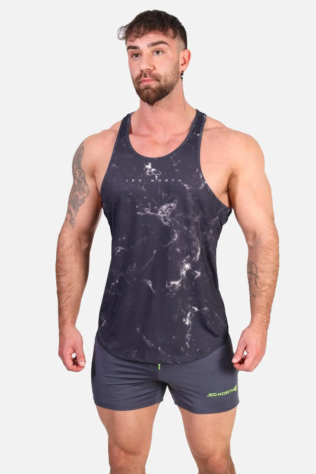 Jed North graphic muscle stringer marble tank top in dark gray marble pattern with white veining and neon green trim
