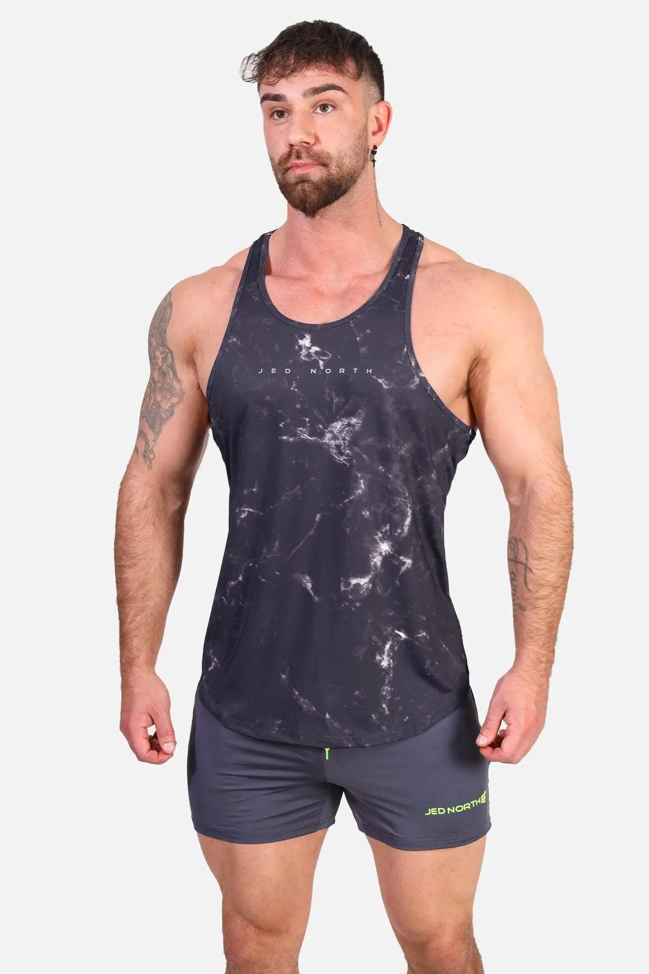 Jed North graphic muscle stringer marble tank top in dark gray marble pattern with white veining and neon green trim