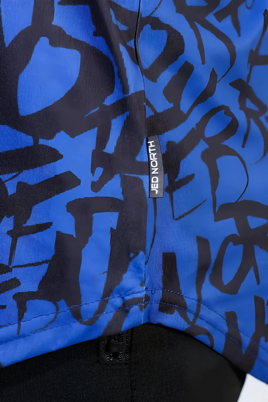 Navy graffiti patterned jed north graphic muscle stringer fabric with blue and black designs and brand tag visible
