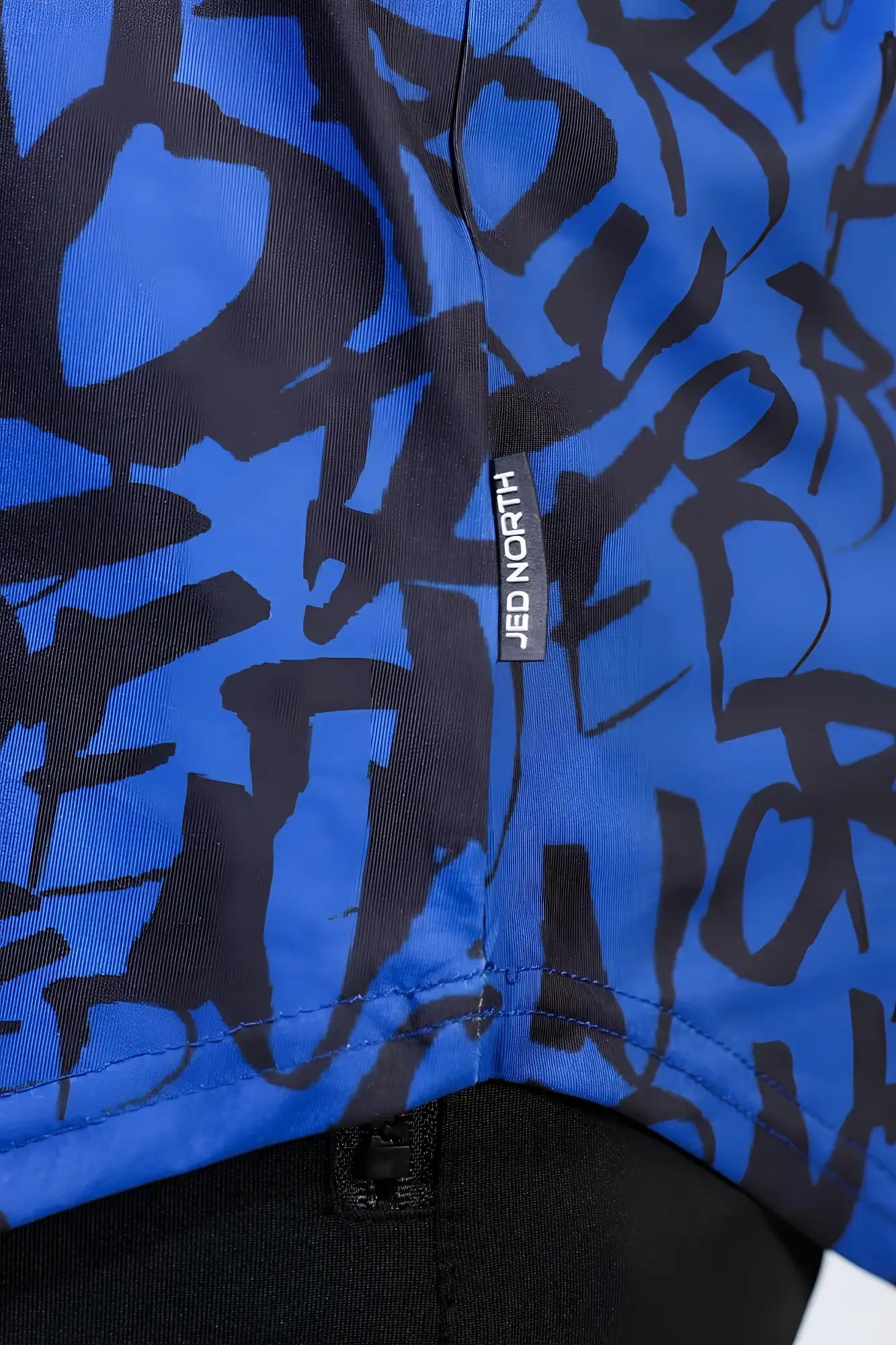 Navy graffiti patterned jed north graphic muscle stringer fabric with blue and black designs and brand tag visible