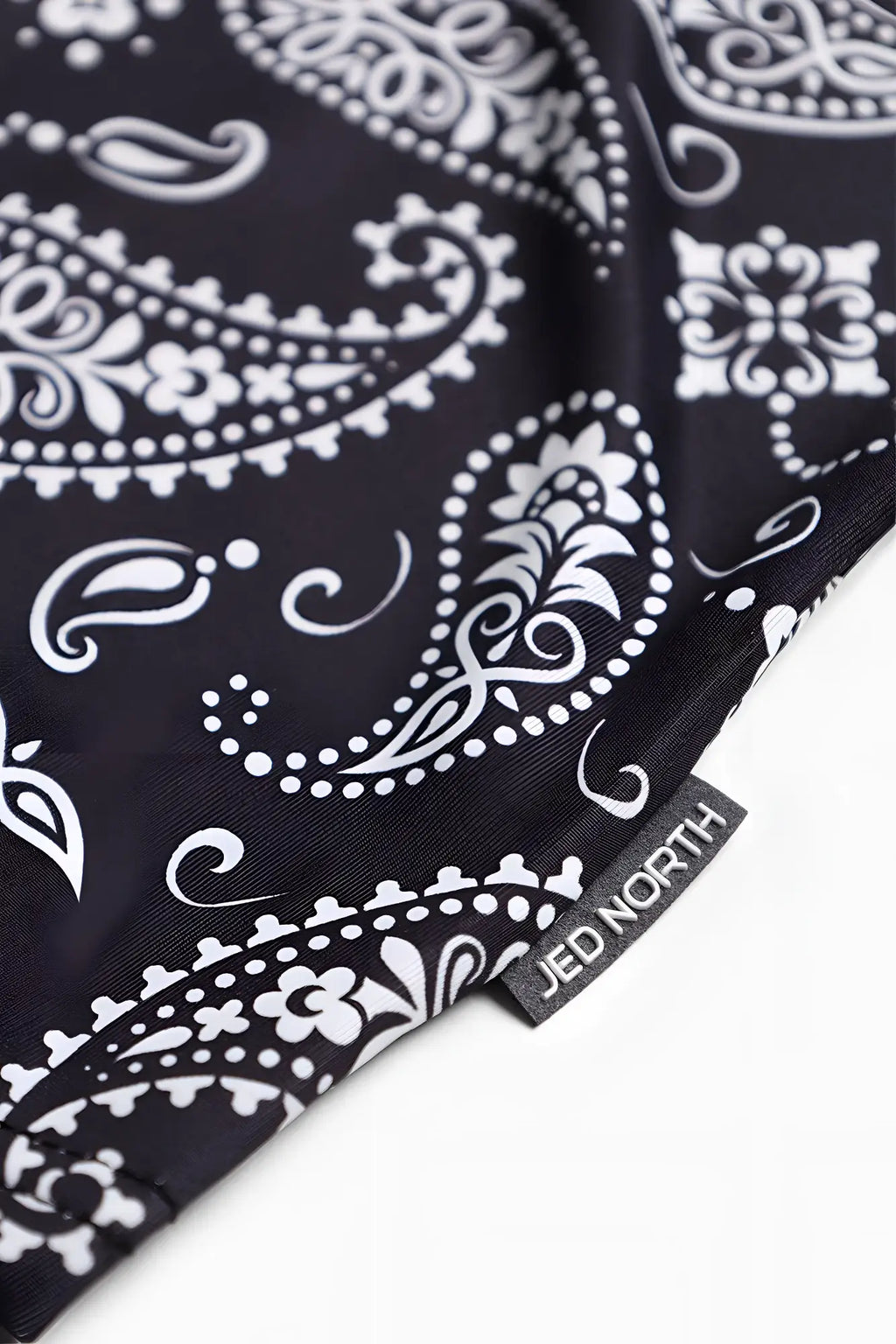 Graphic muscle stringer paisley with black bandana fabric featuring white paisley and floral patterns