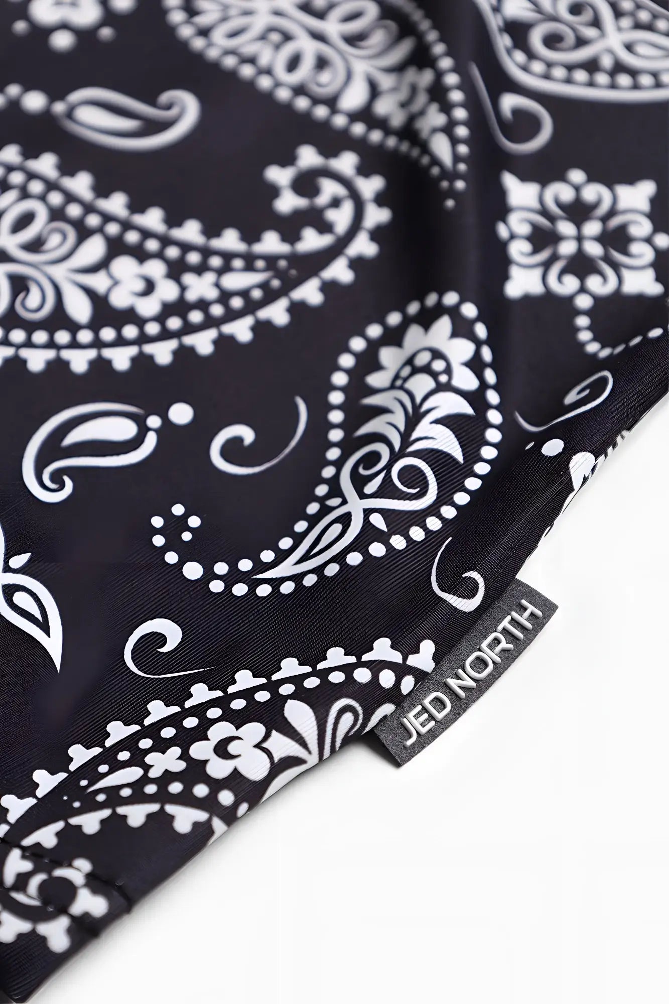 Graphic muscle stringer paisley with black bandana fabric featuring white paisley and floral patterns