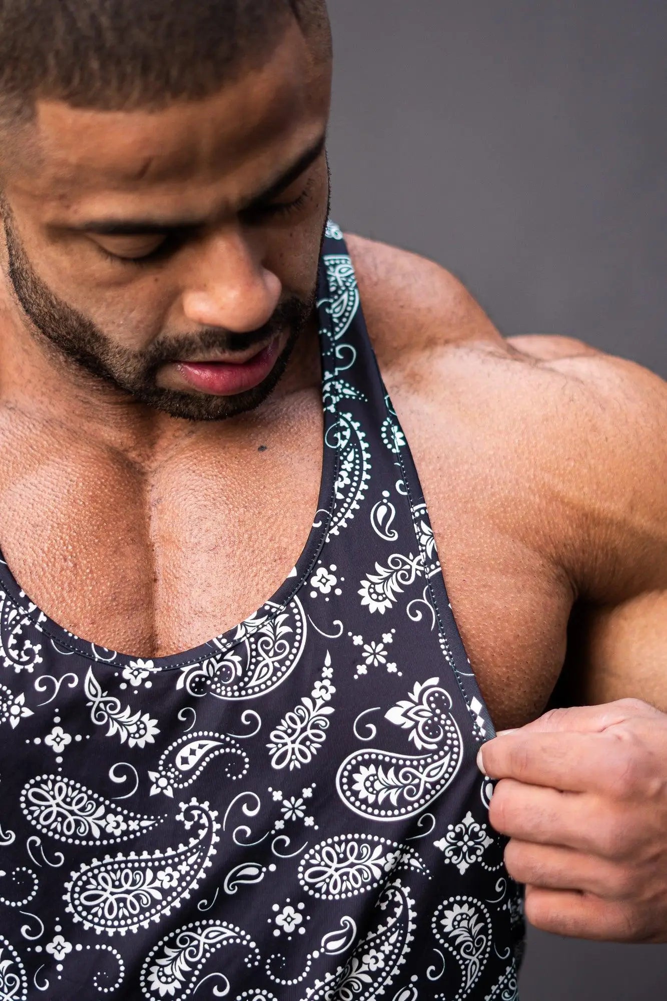 Black tank top graphic muscle stringer with white paisley and floral patterns ideal for casual wear