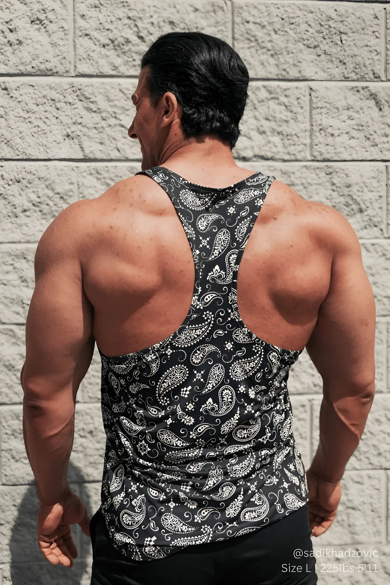 Black and white paisley patterned racerback tank top showing the back side of the graphic muscle stringer paisley