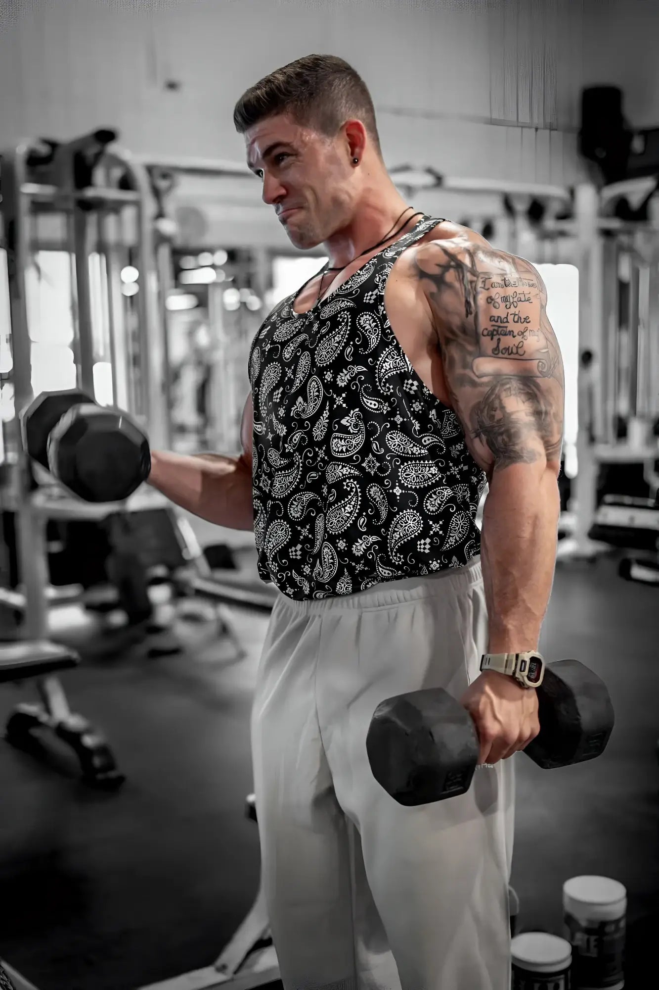 Black and white paisley patterned graphic muscle stringer tank top with a fitted sleeveless design