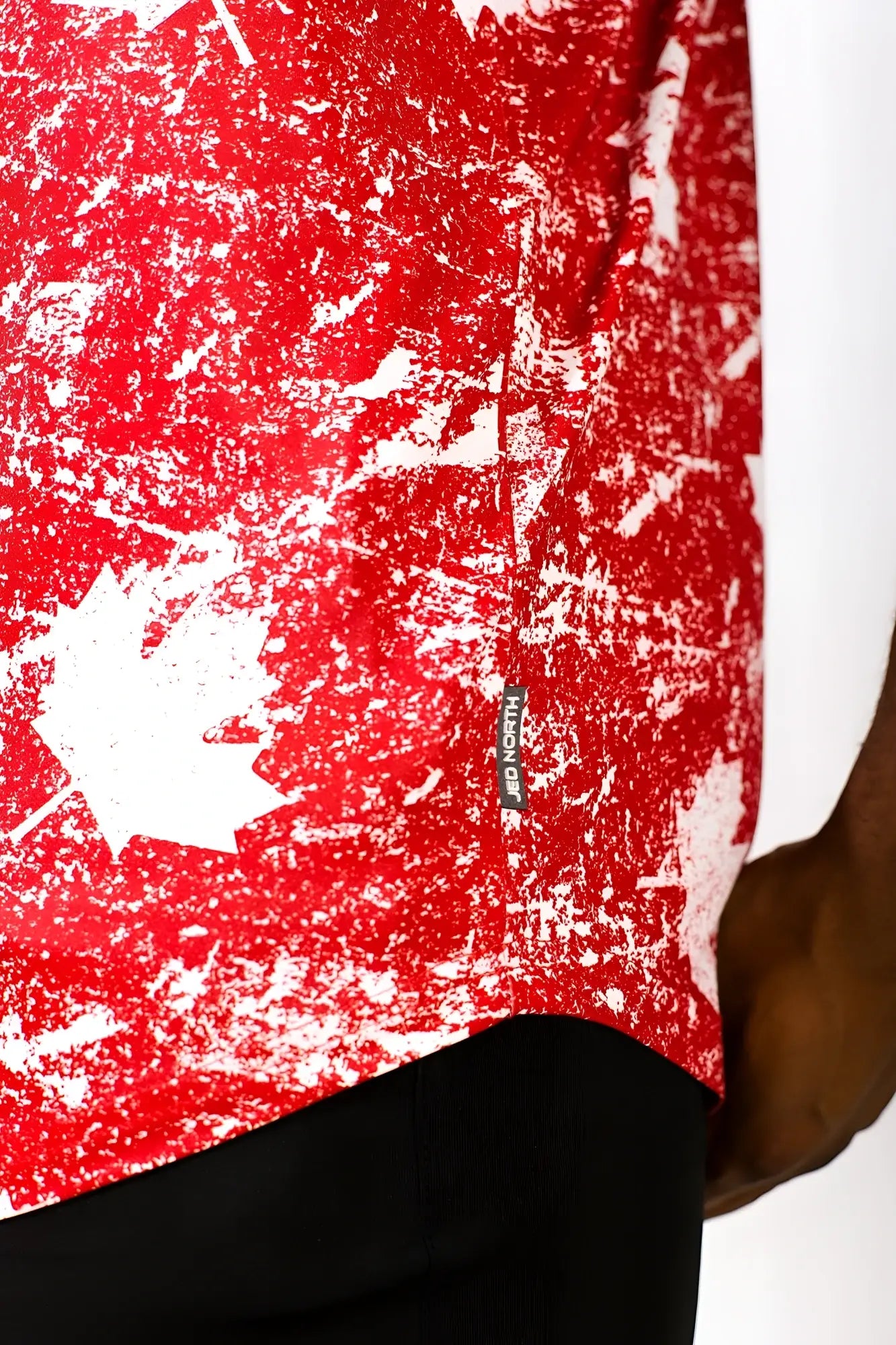 Red and white distressed maple leaf graphic muscle stringer t-shirt with visible brand tag in front view