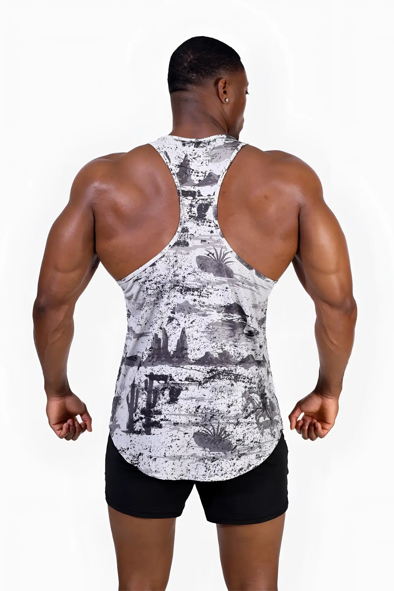 A black and white graphic muscle stringer tank top with a distressed desert print of cacti and rock formations