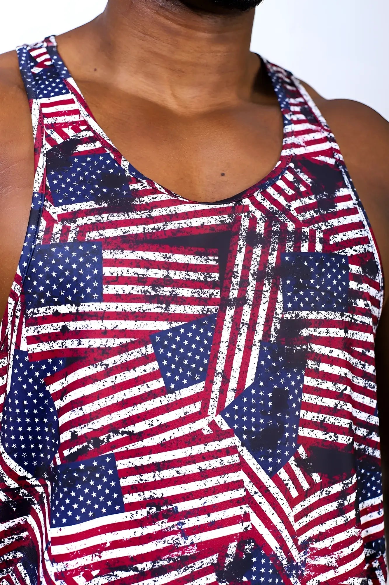 Graphic muscle stringer tank top with vibrant distressed USA flag pattern in red white and blue for casual wear