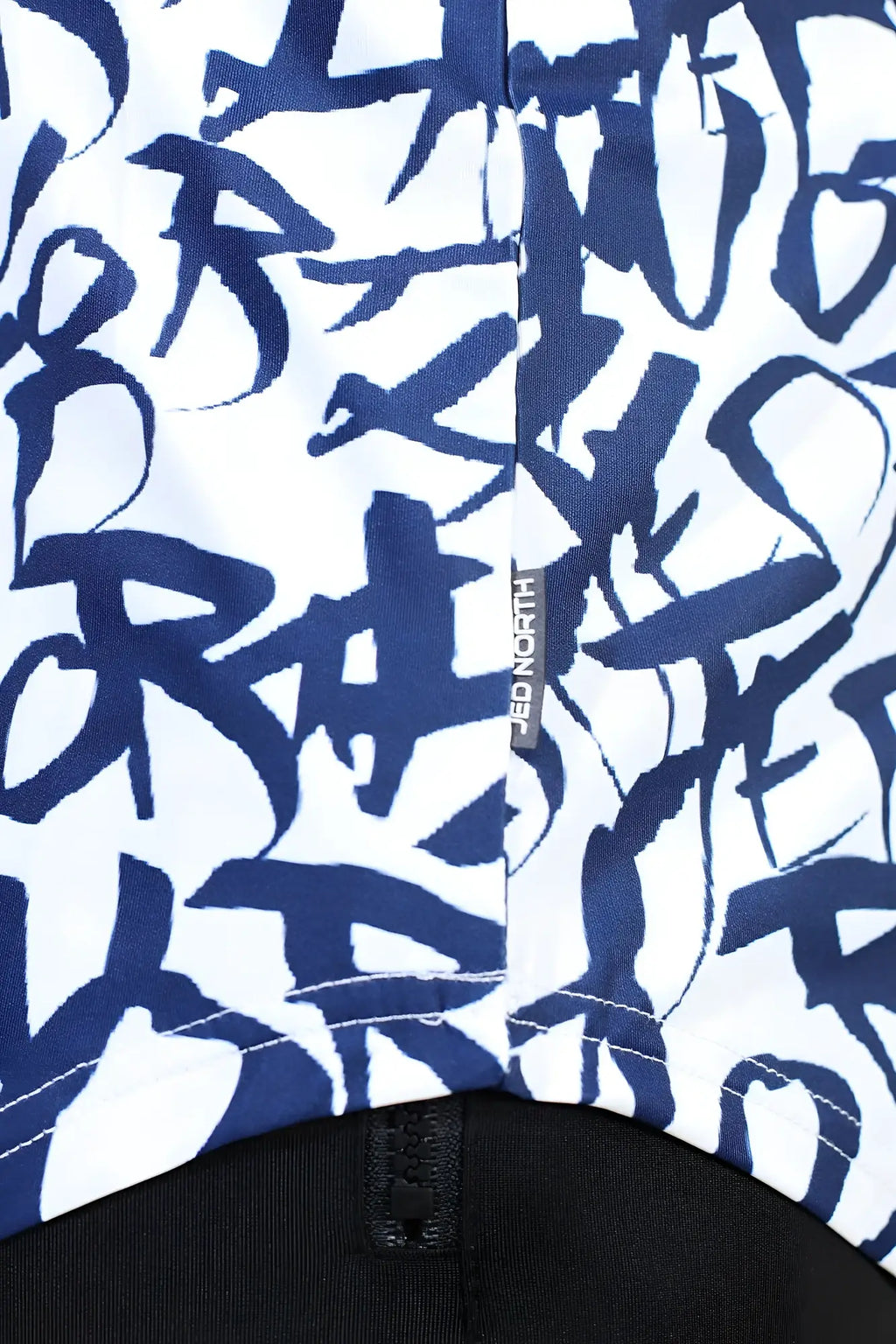 White jed north graphic muscle stringer jacket with bold navy blue graffiti lettering and black zipper at the bottom