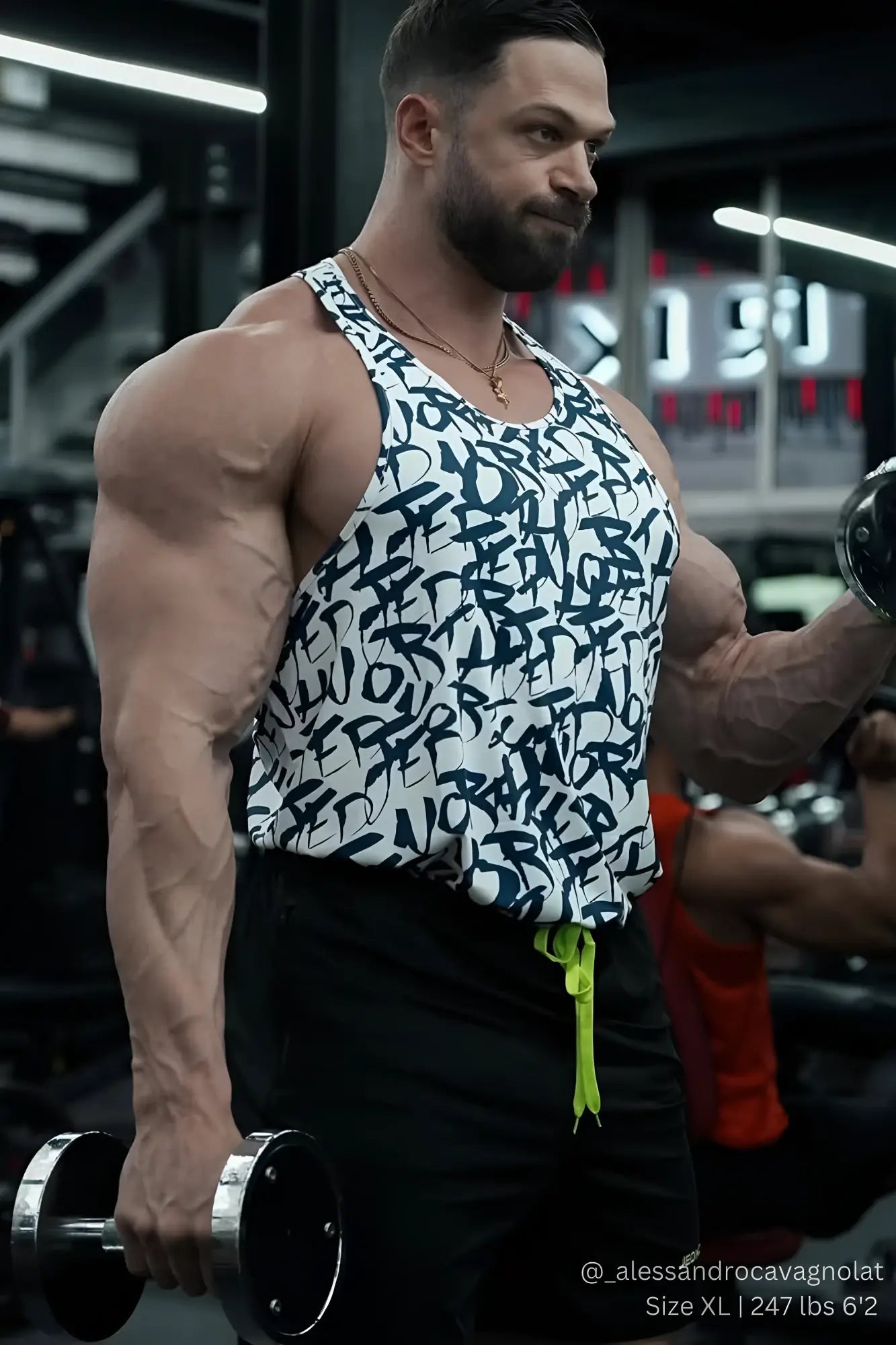 A man wearing a Jed North graphic muscle stringer white graffiti tank top and neon green drawstring pants