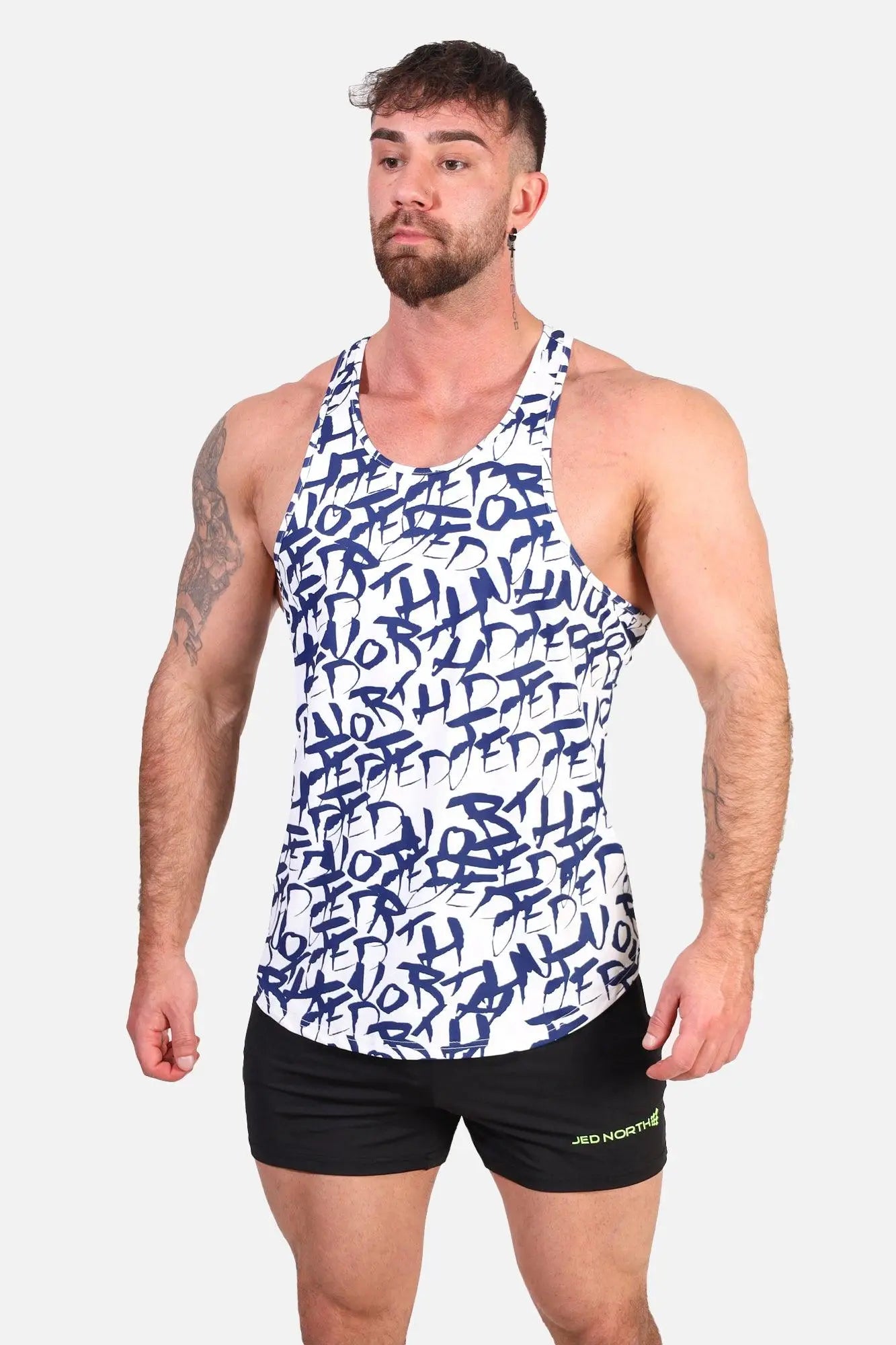 Jed North graphic muscle stringer white tank top with bold blue graffiti style lettering across the front