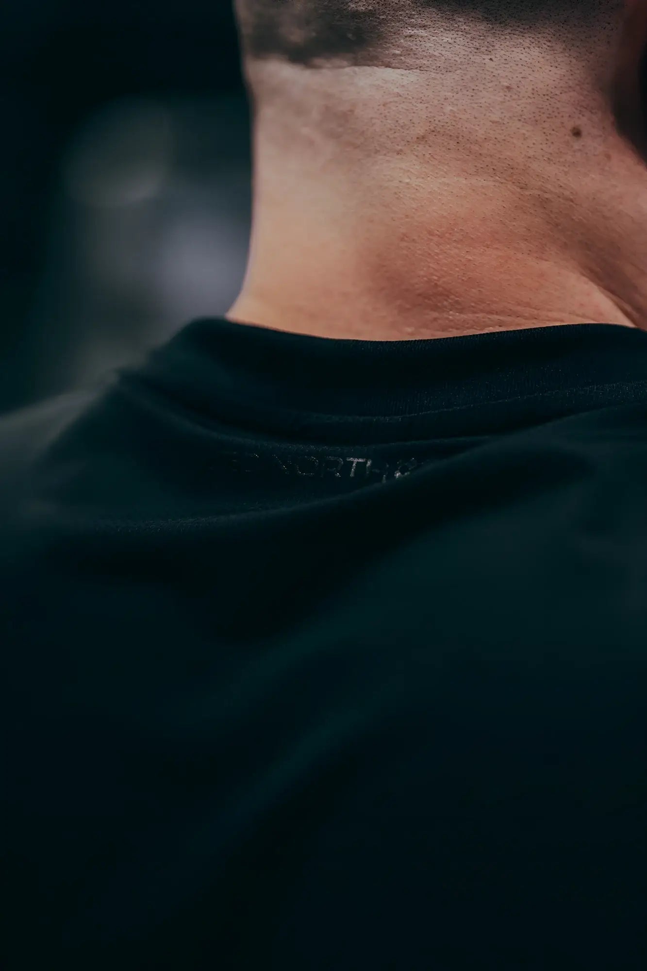 Black JN Active Muscle Tee crewneck t-shirt with subtle the north face embroidery along the neckline