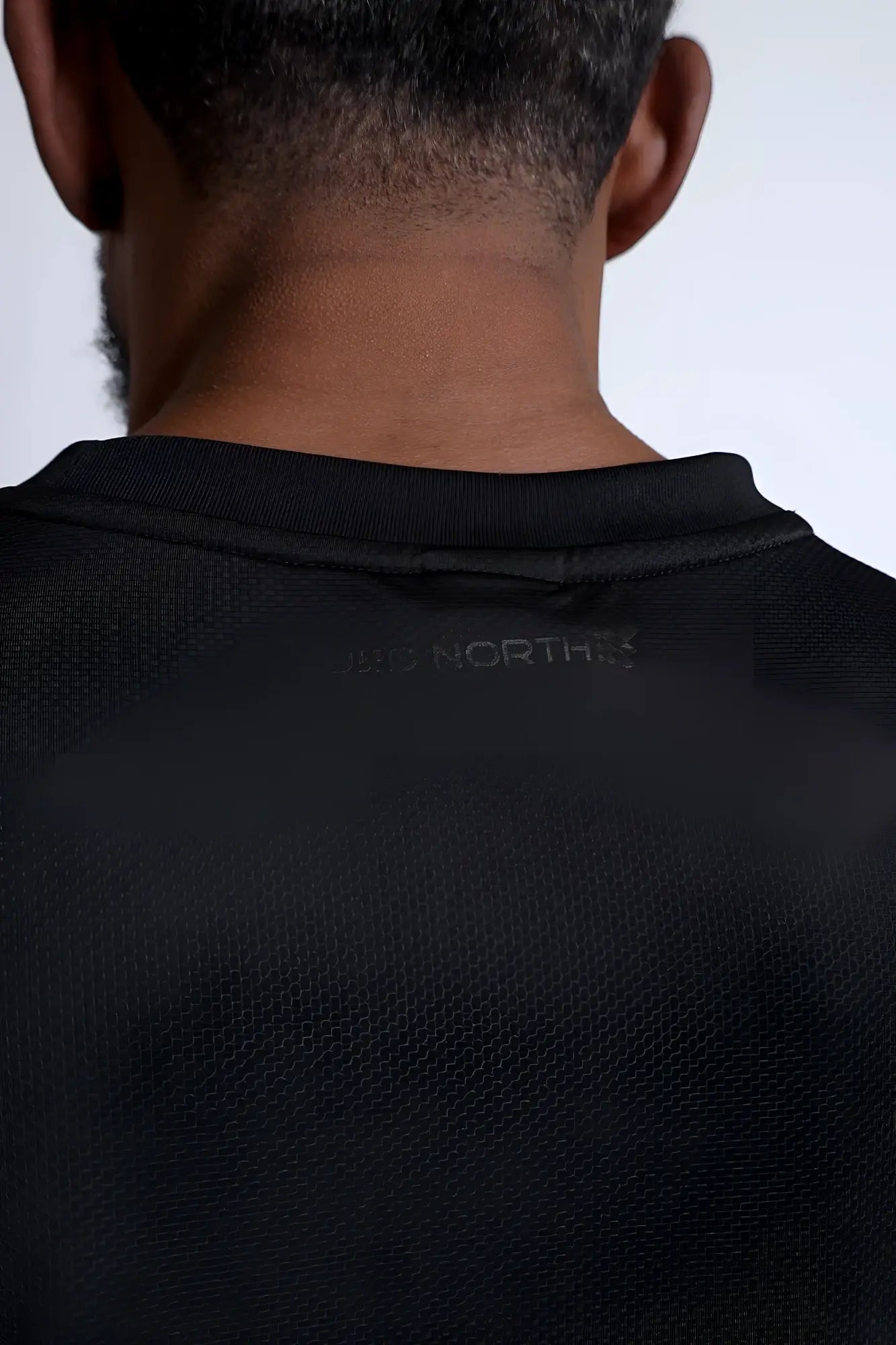 Black north face jn active muscle tee with subtle textured fabric and ribbed crew neckline for performance use